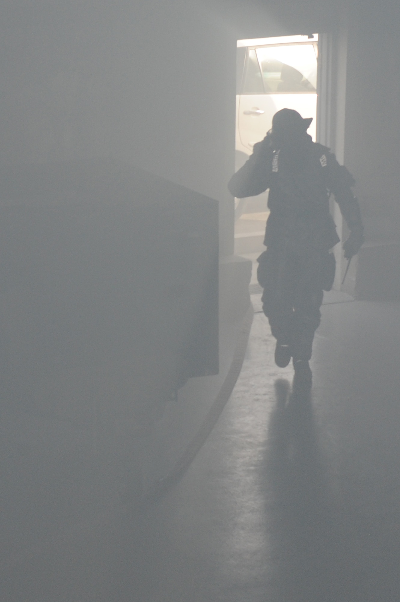 SOUTHWEST ASIA - A member of the 380th Expeditionary Civil Engineer Squadron Fire Department enters a building during a major accident response exercise at the 380th Air Expeditionary Wing July 25, 2012. The exercise focused on the actions of first responders, including the fire department, security forces and medical personnel. (U.S. Air Force photo/Master Sgt. Scott MacKay)