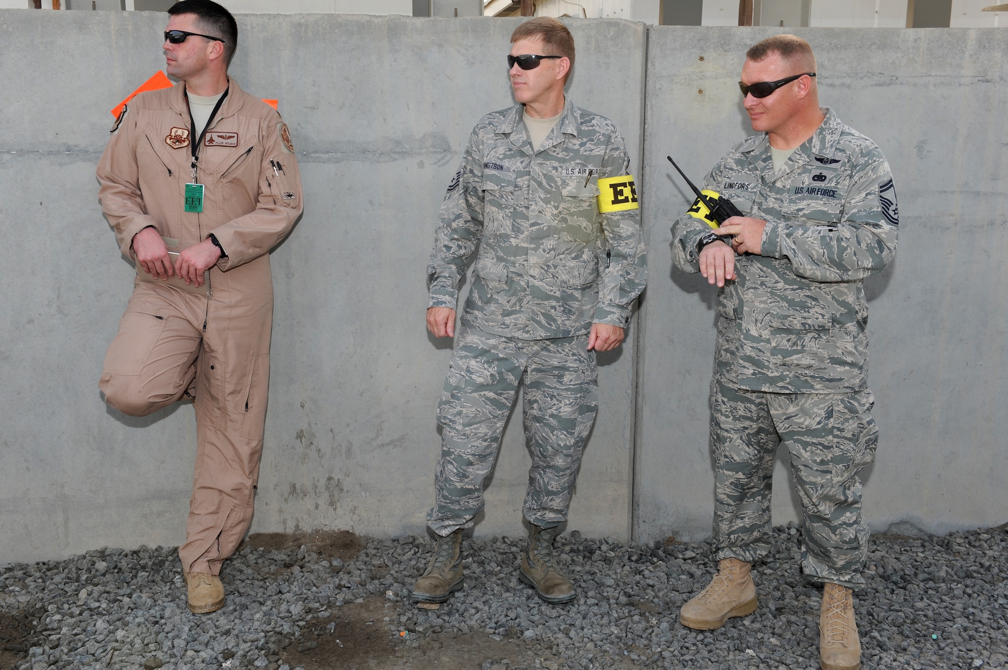 SOUTHWEST ASIA - U.S. Air Force Maj. B.J. Holman, Master Sgt. Michael Knutson and Senior Master Sgt. Russell Lindfors, 380th Air Expeditionary Wing Exercise Evaluation Team members, observe the reaction  time of the 380th Expeditionary Civil Engineer Squadron Fire Department during a major accident response exercise July 25, 2012. The fire department was on scene three minutes after calls started flooding the command post. (U.S. Air Force photo/Master Sgt. Scott MacKay)