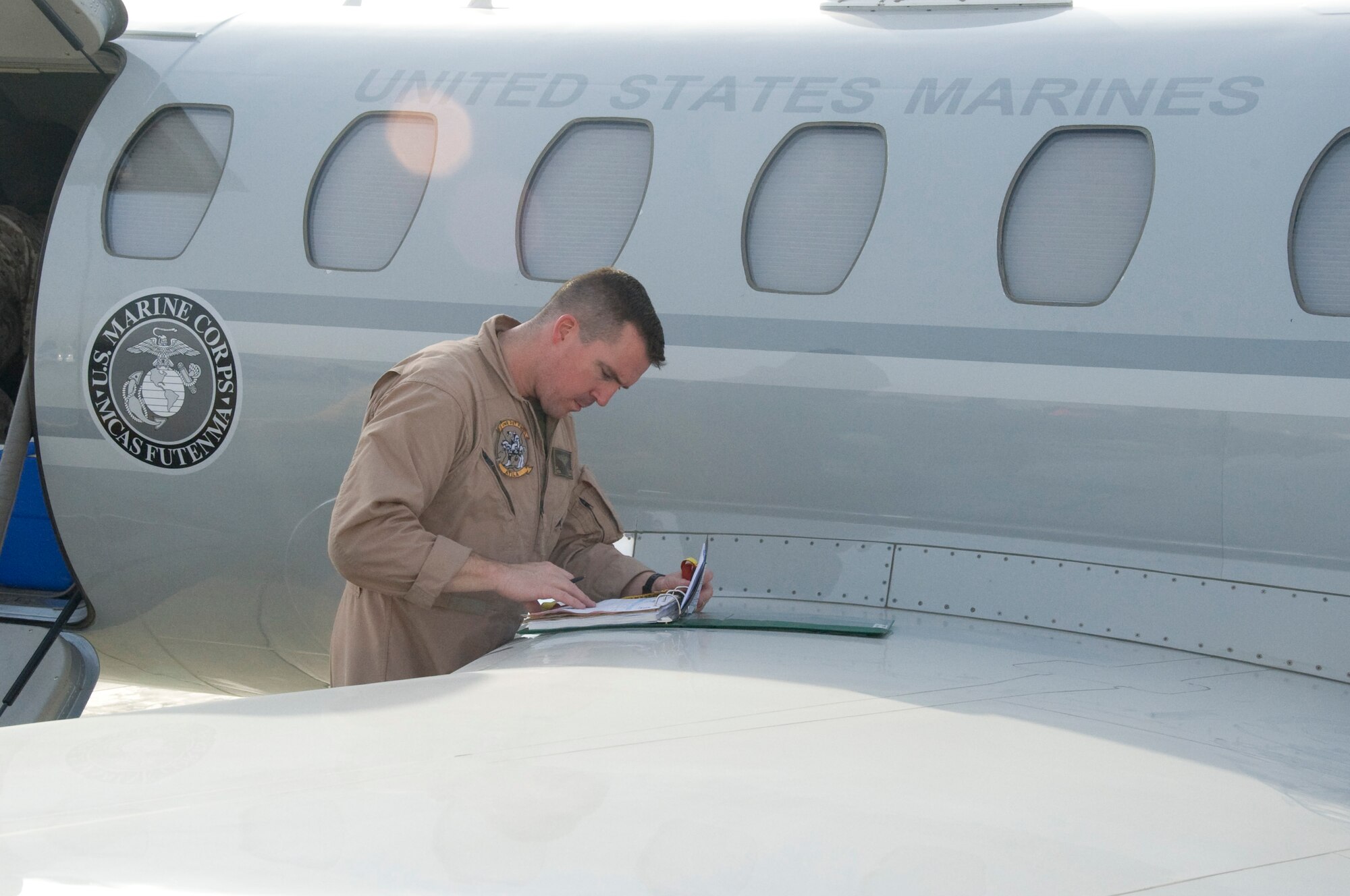 Marine Corps Lt. Col. Brian Blalock, VMR Detachment aircraft commander, makes final preparations before flying to Afghanistan for a mission in Southwest Asia July 26, 2012. The detachment receives between 40 and 60 travel requests each month for military leadership, distinguished visitors and anyone deemed mission critical around the area of responsibility. (U.S. Air Force photo/Senior Airman Bryan Swink)