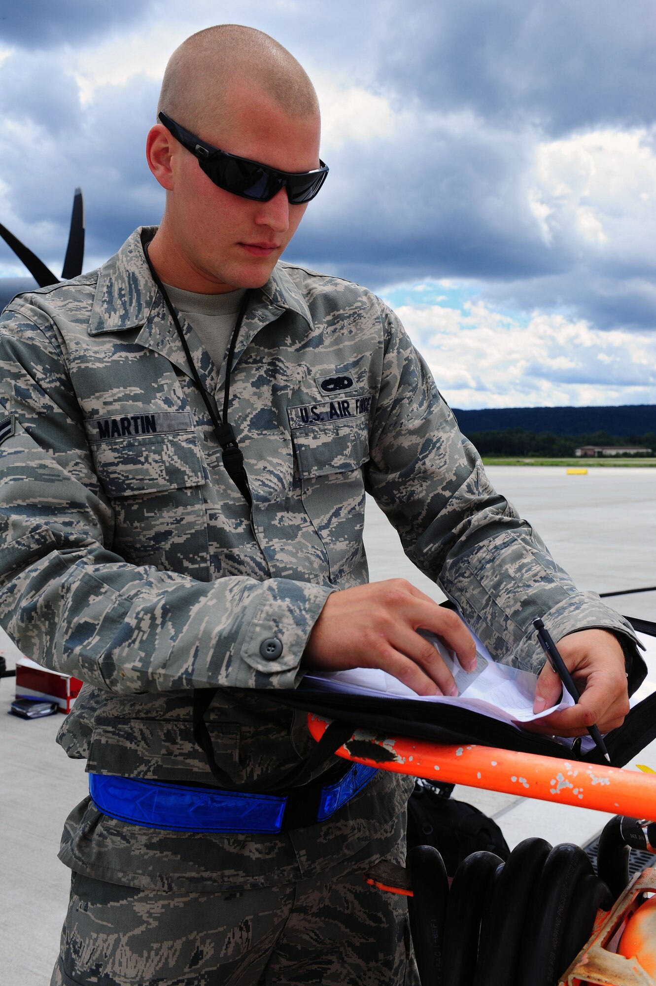 Airman 1st Class Brock Martin, 86th Aircraft Maintenance Squadron C-130J crew chief, updates aircraft documents at the flightline on Ramstein Air Base, Germany, July 11, 2012.  The members of the 86 AMXS safely, reliably, and compliantly provide combat-ready C-130J, Designated Visitor Operational Support aircraft and equipment to support European Command, Central Command, and African Command mission taskings. (U.S. Air Force photo/Airman 1st Class Holly Cook)
