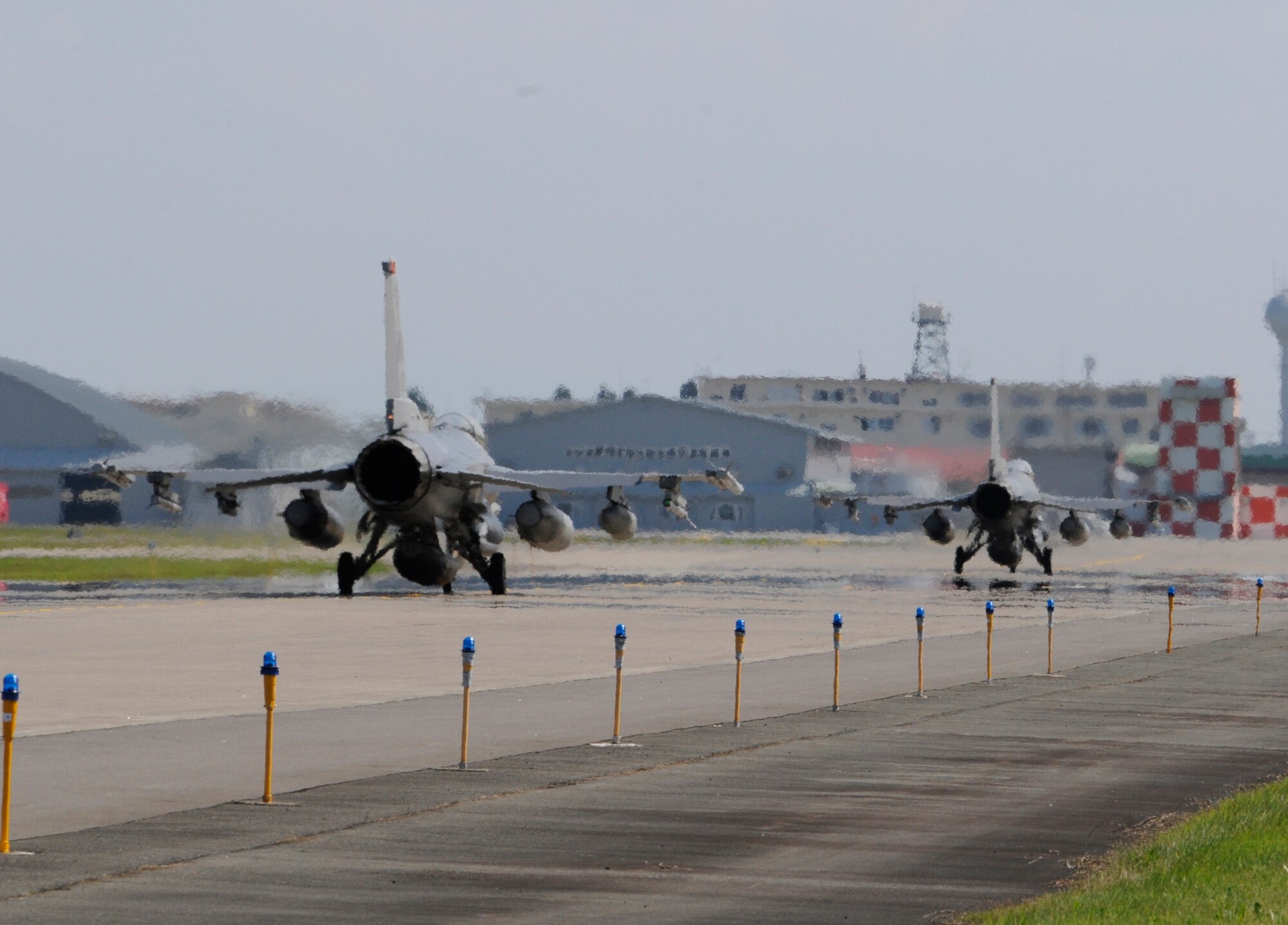 The 35th Fighter Wing F-16 Fighting Falcons of Misawa Air Base, Japan, taxi down the runway July 26, 2012, for the first time since temporarily suspending operations after the loss of an F-16, July 22, 2012. The certification and revalidation of all aircraft was performed by the 35th Fighter Wing to ensure aircraft were ready to resume flight operations. (U.S. Air Force photo by Airman 1st Class Zachary Kee/Released)