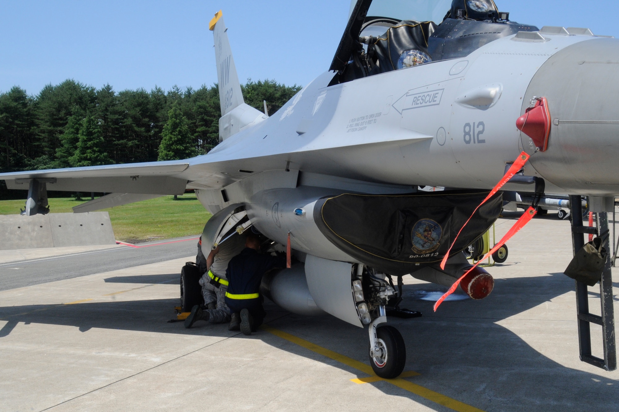 Airmen perform safety checks on an F-16 Fighting Falcon at Misawa Air Base, Japan, July 26, 2012. The purpose of safety checks is to ensure that both the pilot and the jet reach their destination without problems. Safety is a top priority for all maintainers, which is another reason these checks are performed daily. (U.S. Air Force photo by Airman 1st Class Zachary Kee/Released)