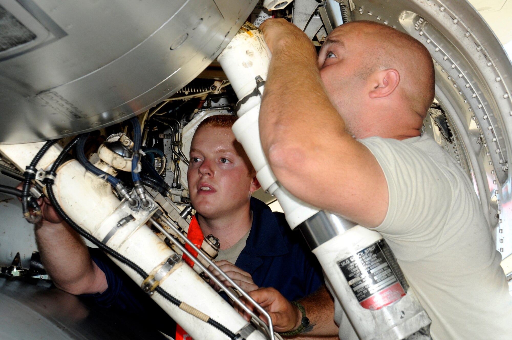 U.S. Air Force Staff Sgt. John Wyatt, right, 35th Maintenance Squadron sheet metal technician, and Senior Airman Zachary Hurt, 14th Fighter Squadron aircraft maintainer, inspect the inside of an F-16 Fighting Falcon at Misawa Air Base, Japan, July 26, 2012. The safety of pilots and the capability of keeping jets ready to fly are major priorities for all maintainers. (U.S. Air Force photo by Airman 1st Class Zachary Kee/Released)