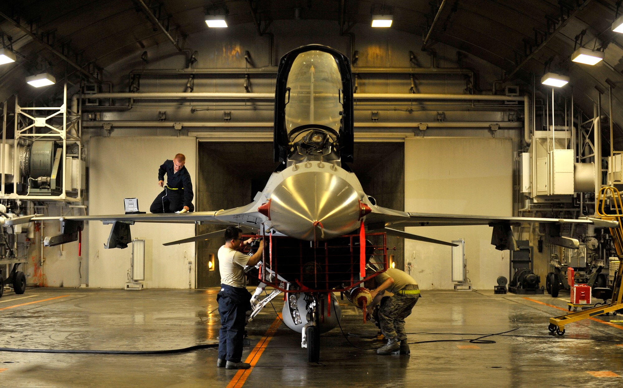 U.S. Air Force Airmen from the 35th Maintenance Group inspect an F-16 Fighting Falcon after installing a new engine at Misawa Air Base, Japan, July 25, 2012. Stringent checks were made on all 35th Fighter Wing aircraft to ensure their safety after a pilot ejected from his F-16 in the Pacific Ocean on July 22. The 35 FW subsequently grounded its aircraft for additional inspections coupled with stringent routine checks before resuming its flying mission July 26. (U.S. Air Force photo by Staff Sgt. Nathan Lipscomb/Released) 