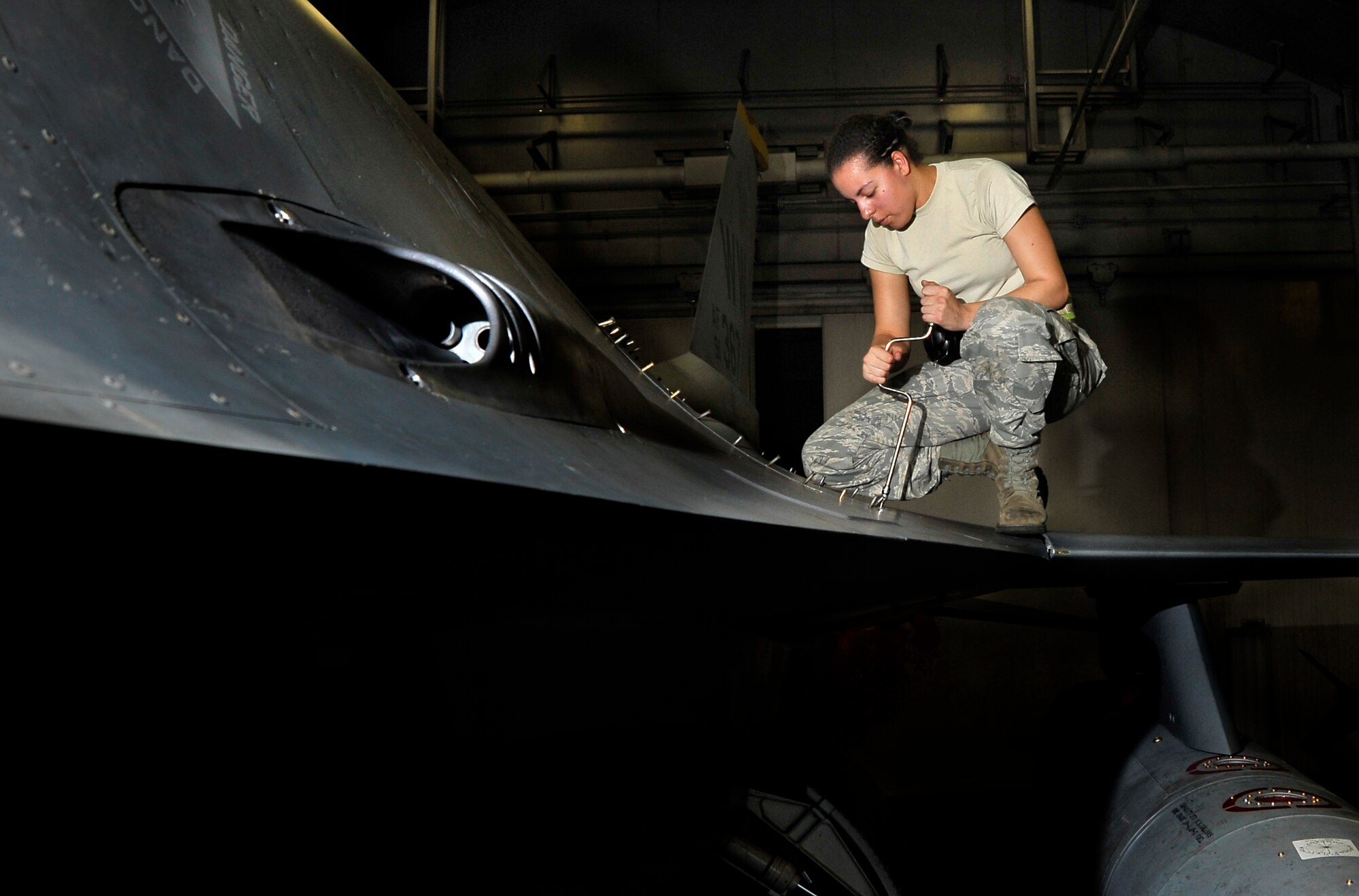 U.S. Air Force Airman 1st Class Simone Hodge, 14th Fighter Squadron weapons maintenance, seals an aircraft panel after completing a hydraulic bleed and leak check on an F-16 Fighting Falcon’s gun system at Misawa Air Base, Japan, July 25, 2012. The hydraulic bleed and leak makes sure the aircraft is not losing valuable hydraulic fluid. After an F-16 pilot ejected in the Pacific Ocean on July 22, 35th Fighter Wing aircraft were grounded and ceased flying operations locally and off-station. During that time, all aircraft received additional inspections along with their normal stringent checks. The wing continually validates the safety of its aircraft and has resumed flying to meet mission requirements. (U.S. Air Force photo by Staff Sgt. Nathan Lipscomb/Released) 