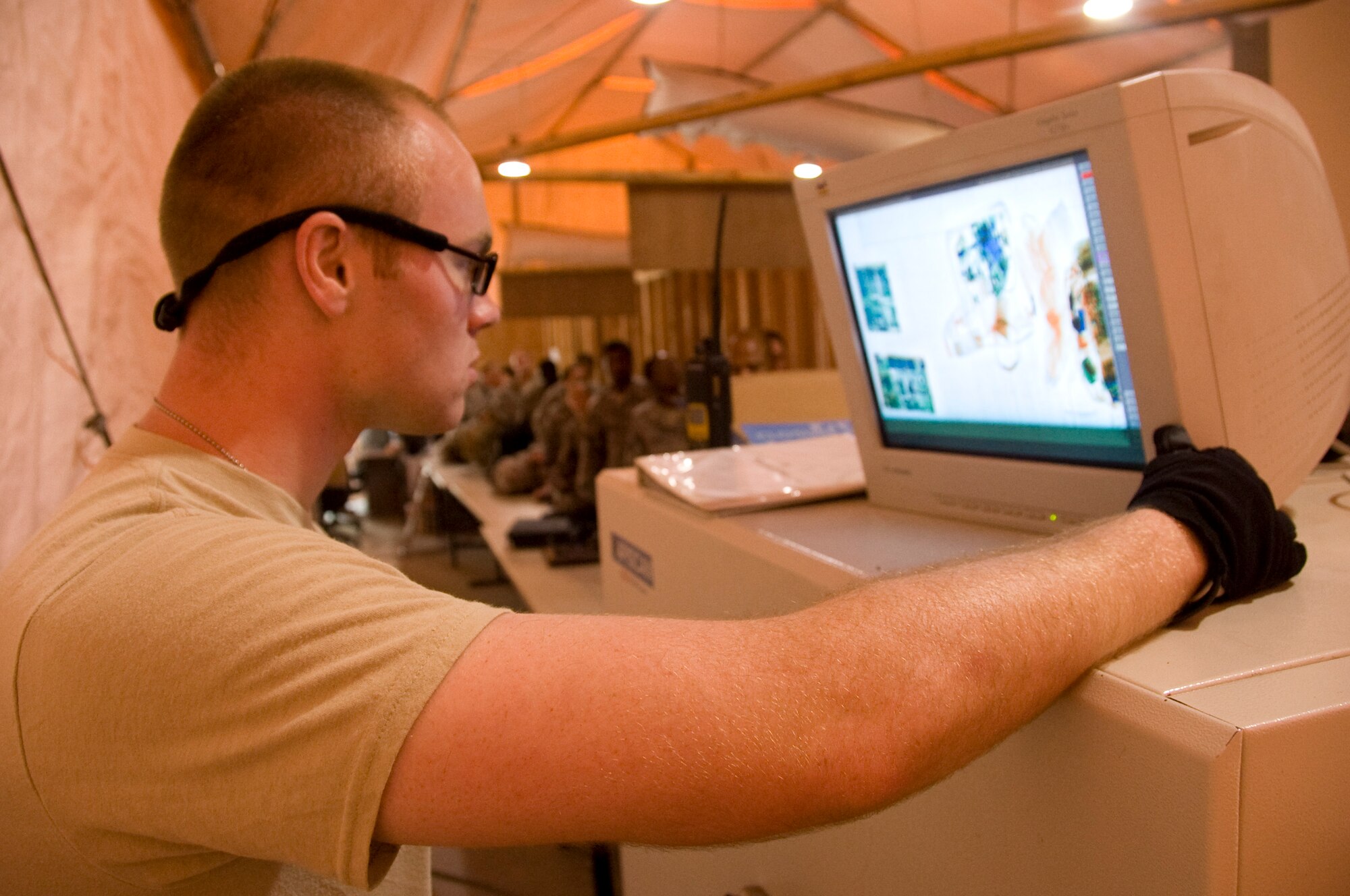 Airman 1st Class T.J. Cotter, 8th EAMS passenger service representative, carefully reviews and scans every piece of carry-on luggage passengers takes with on their trip home from Southwest Asia July 22, 2012. One of the top priorities of the Airmen of the 8th EAMS is to ensure all passengers traveling to the continental United States adhere to the Transportation Security Administration guidelines. (U.S. Air Force photo/Senior Airman Bryan Swink)