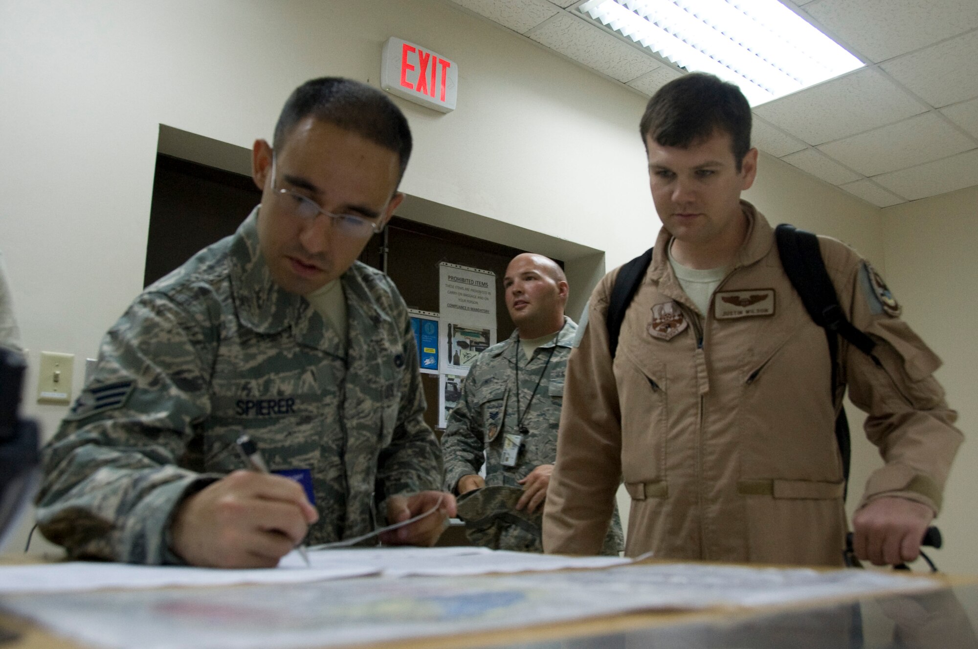 Senior Airman Joshua Spierer, 8th Expeditionary Air Mobility Squadron passenger service representative, checks in departing passengers from Southwest Asia July 22, 2012. These ‘Port Dawgs,’ also known as ‘The Ocho’s,’ support approximately 9,000 transiting service members each month. (U.S. Air Force photo/Senior Airman Bryan Swink)