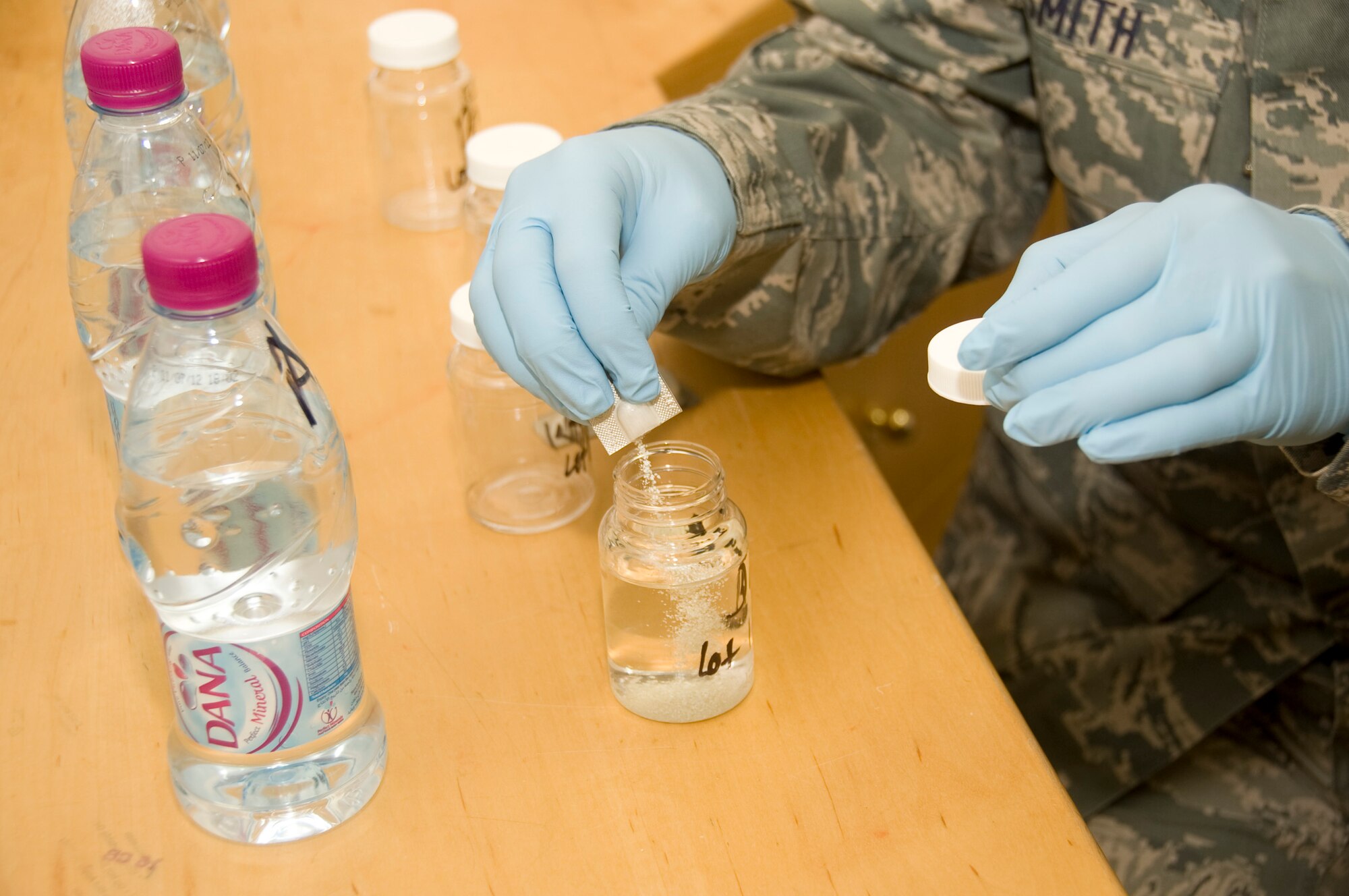 Senior Airman Ryan Smith, 379th Expeditionary Medical Group Bioenvironmental environmental program manager, pours agar into a pulled sample of water July 20, 2012 here. The test is conducted to ensure no bacteria or ecoli is found in the bottled water. Smith ensures all water consumed by service members here adheres to Air Force Central standards. (U.S. Air Force photo/Senior Airman Bryan Swink)