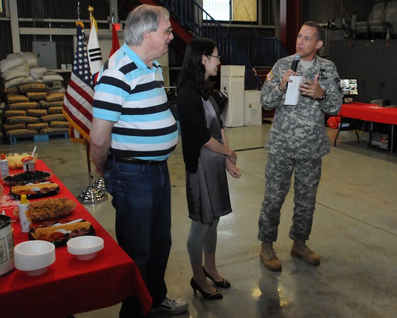 Col. Donald E. Degidio, Jr. (right), Commander, U.S. Army Corps of Engineers, Far East District, asks newcomers to stand up during July 2011 Castle Call. Upon hearing his name, Dave Newcomer (left), Supervisor Program Analyst, stood up. New comer has always entertained his friends and coworkers with his friendly and cheerful personality. (Photo by Patrick Bray)