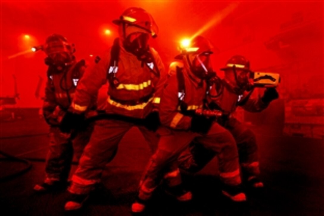 U.S. Navy sailors assigned to the aircraft carrier USS Dwight D. Eisenhower practice firefighting during a drill while under way in the Arabian Sea, July 24, 2012. The Eisenhower is deployed to the U.S. 5th Fleet area of responsibility to conduct maritime security operations, theater security cooperation efforts and support missions as part of Operation Enduring Freedom.