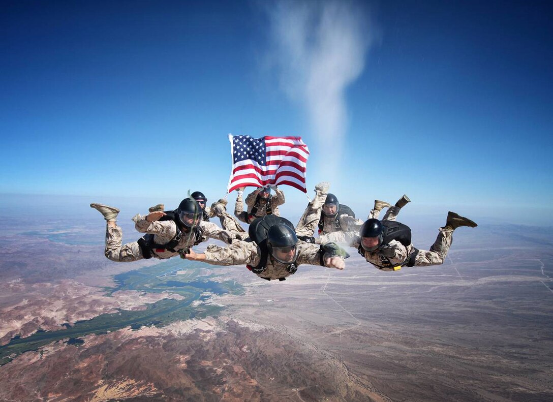 Marine Corps Military Free Fall Instructors assigned to Marine Detachment — Fort Bragg, release the ashes of Sgt. Brett Jaffe (1971-2012), a Marine rigger, above Phillips Drop Zone at Yuma Proving Grounds, Ariz., on July 26, 2012. "It was an honor and privilege to take this Marine on his last jump and give him a proper hail and farewell," said Staff Sgt. Marty Rhett. Marines in photo (clockwise, starting with the flag): Gunnery Sgt. Brian Boger, Gunnery Sgt. Mike Latham, Gunnery Sgt. Jimmy Smith, Staff Sgt. Lennie Castro, Staff Sgt. Seth Wright, Staff Sgt. Marty Rhett.