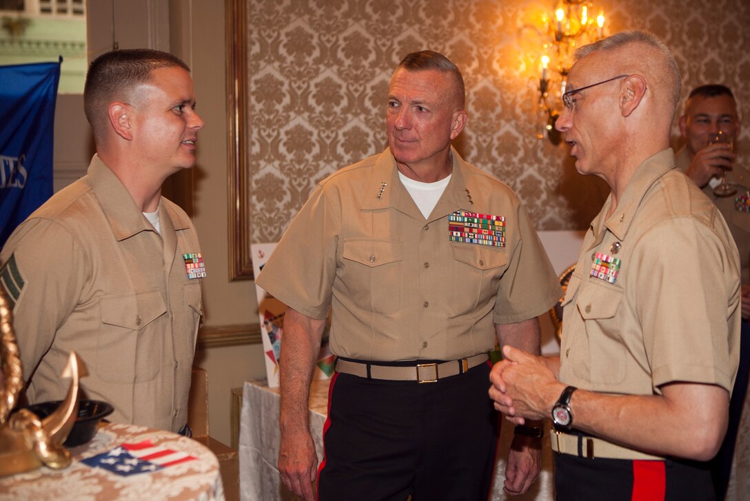 Staff Sgt. Brett M. Bartels talks with Lt. Gen. Steven A. Hummer, commander of Marine Forces Reserve and Marine Forces North, and Brig. Gen. Roger R. Machut, commander of 4th Marine Logistics Group, at the Navy League’s second annual “A Taste ‘n Toast to our Armed Services” at the Bourbon Orleans Hotel here, July 26. During the gala, the service members of the year from each service were recognized. Among them was Bartels, a career planner with Inspector-Instructor Communications Company, Headquarters Battalion, 4th Marine Division, and 2011 MARFORRES active duty Marine of the Year. (U.S. Marine Corps photo by Cpl. Marcin Platek/Released)