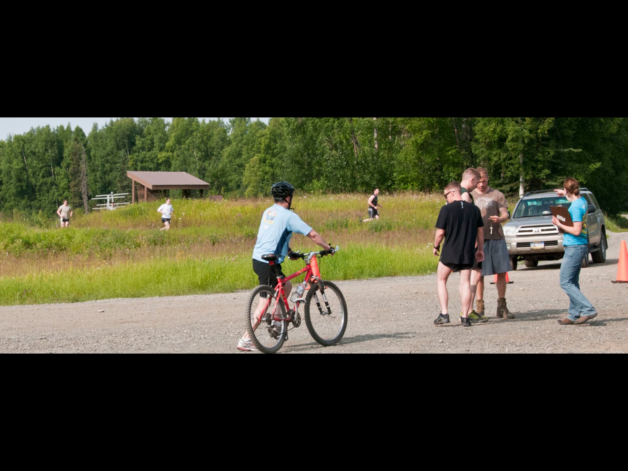 JOINT BASE ELMENDORF-RICHARDSON -- Individual competitors of JBER's four-sport competion here complete the biking and kayaking portions July 20, while the team competitors gear up for the race. Military and community members across the base participated in the Eco Challenge, an annual event hosted by the base fitness centers. National Guard photo by Staff Sgt. N. Alicia Goldberger.