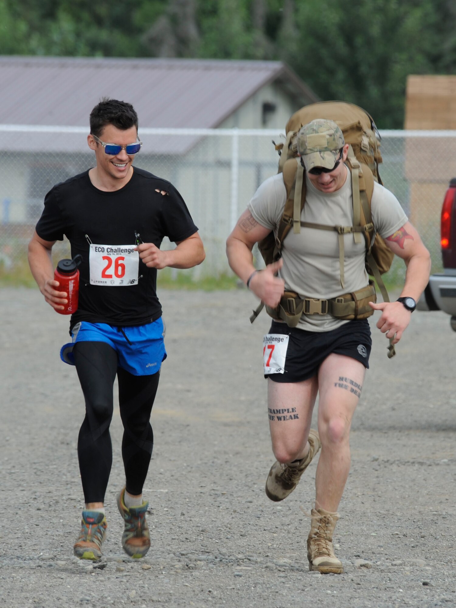 JOINT BASE ELMENDORF-RICHARDSON -- Senior Airman Ethan Brown with the 3rd Air Support Operations Squadron finishes the last leg of a race here July 20, spurred on by Senior Airman Michael Hurt with the 3rd Maintenance Squadron who had already crossed the finish line. Military and community members across the base participated in the Eco Challenge, an annual, multi-sport event hosted by the base fitness centers. National Guard photo by Staff Sgt. N. Alicia Goldberger.