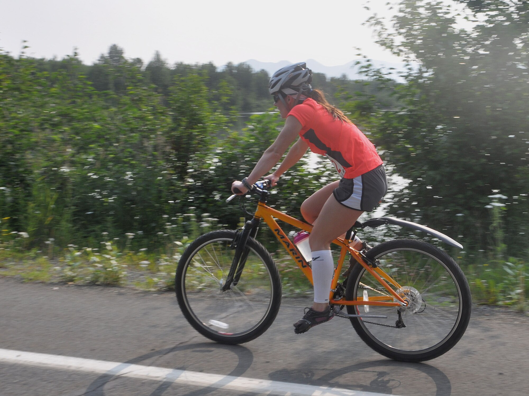 JOINT BASE ELMENDORF-RICHARDSON -- Brittney Miller, a competitor in JBER's annual Eco Challenge, speeds through the bike event here July 20. Military and community members across the base participated in this multi-sport event hosted by the base fitness centers. National Guard photo by Staff Sgt. N. Alicia Goldberger.
