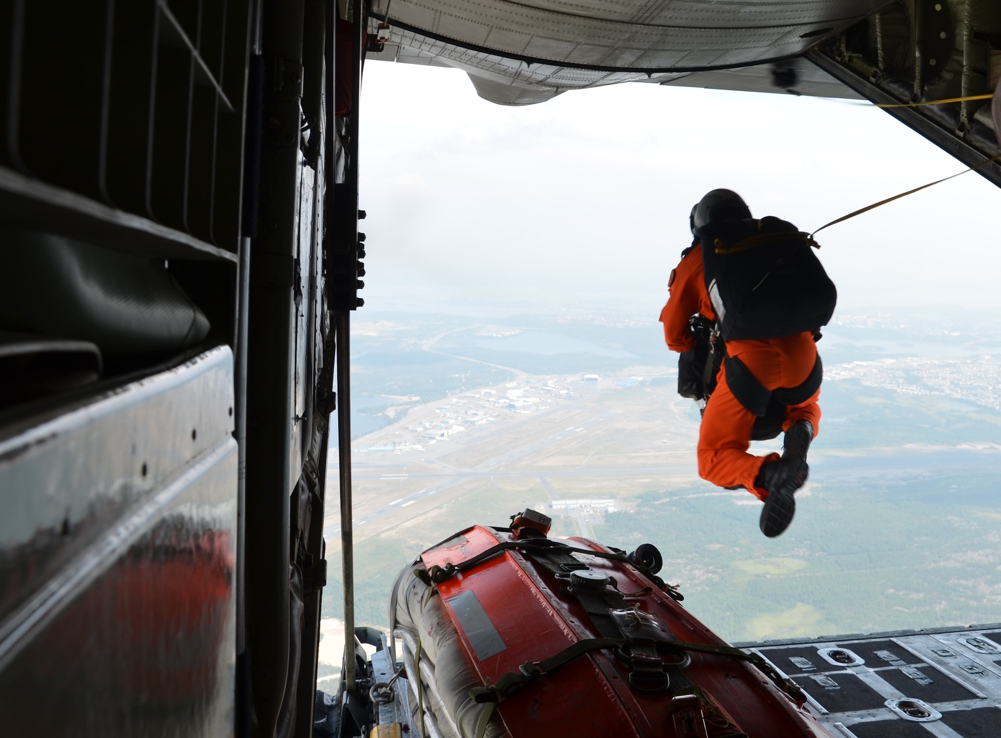 A Canadian search-and-rescue technician does a static line jump from a Canadian C-130 aircraft during a search-and-rescue exercise in Yellowknife, Canada, with Airmen from the 920th Rescue Wing July 17, 2012. Airmen from the 920th RQW at Patrick Air Force Base, Fla., participate in three exercises with Canadian search-and-rescue personnel annually. (U.S. Air Force photo/Staff Sgt. Anna-Marie Wyant)