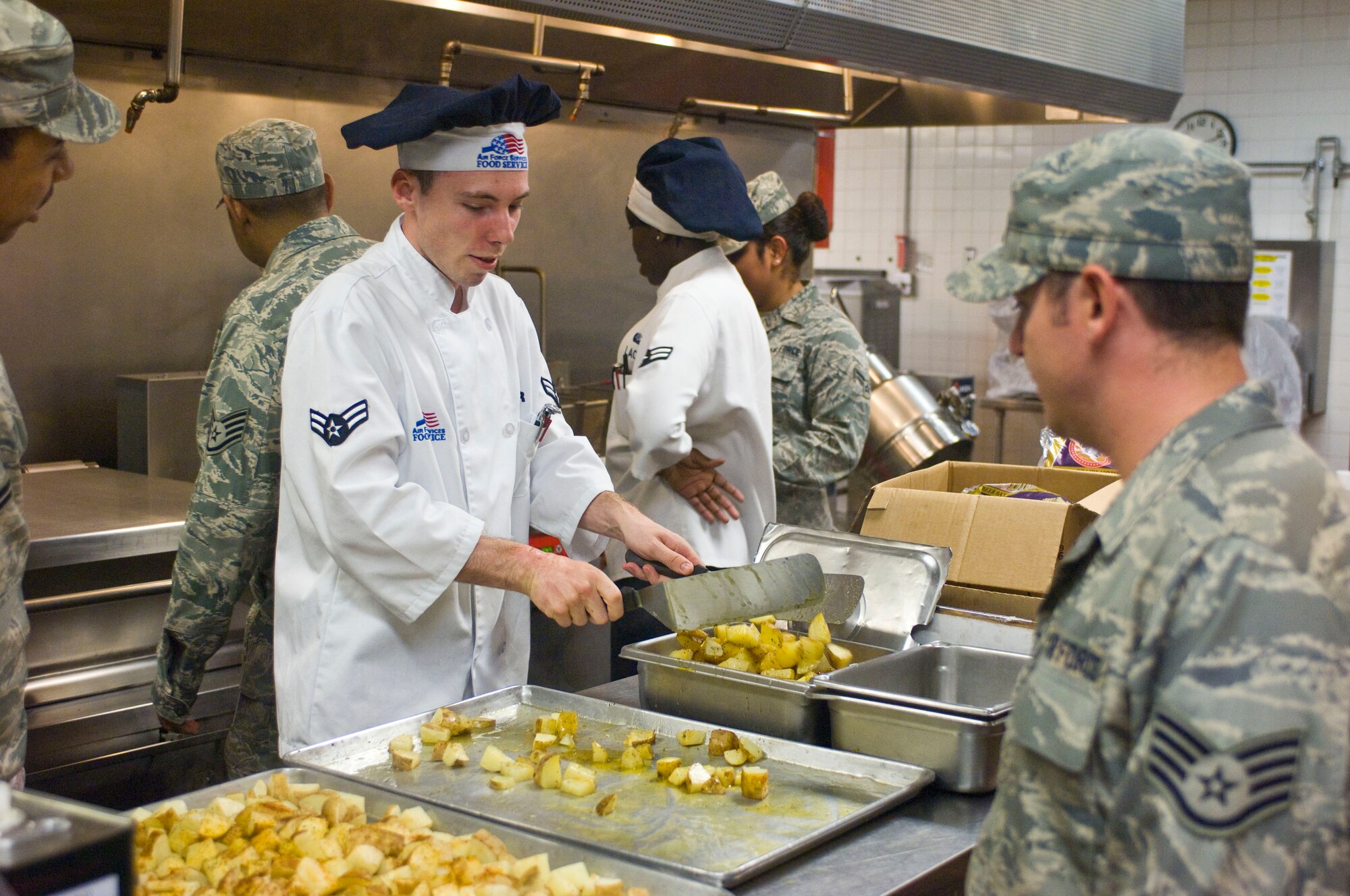 Airman 1st Class Mihai Archer, 99th Force Support Squadron food services specialist, and his coworkers prepare food July 23, 2012, at the Crosswinds Dining Facility on Nellis Air Force Base, Nev. The dining facility is adding more healthy choice options to their menu to offer Airmen foods to maintain a healthy lifestyle. (U.S. Air Force photo by Senior Airman Jack Sanders)
