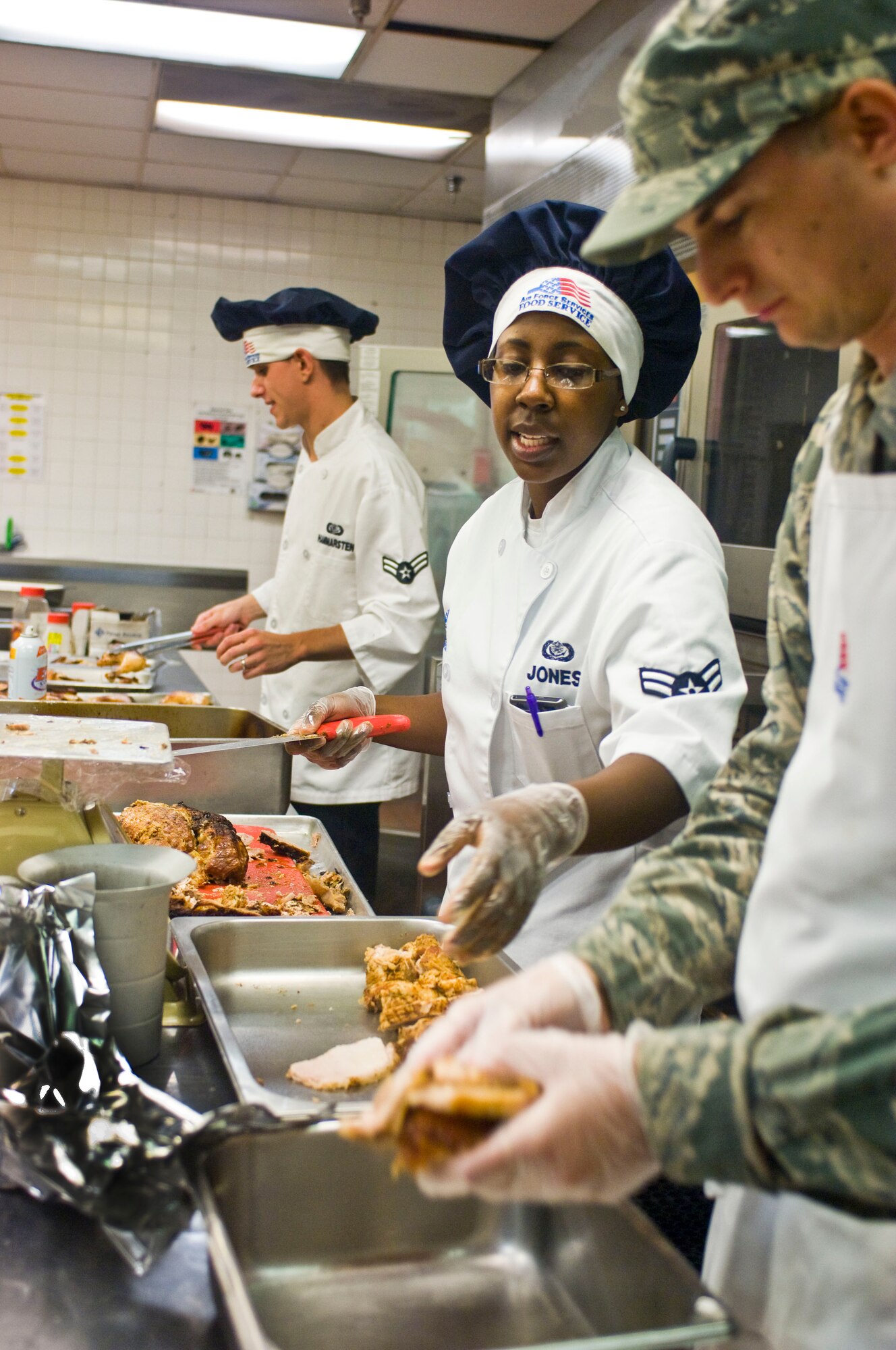 Airman 1st Class Jacqueline Jones, 99th Force Support Squadron food services specialist, instructs fellow Airmen during preparation work July 23, 2012, at the Crosswinds Dining Facility on Nellis Air Force Base, Nev. The Crosswinds Dining Facility uses a nutritional education program called Go for Green to classify food into one of three categories so Airmen can make smarter food choices. (U.S. Air Force photo by Senior Airman Jack Sanders)
