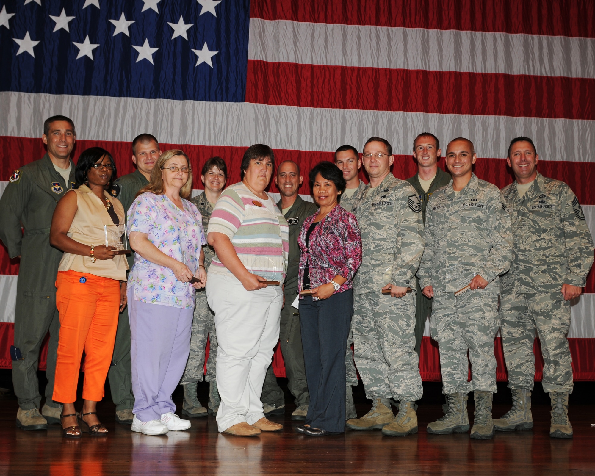The 2012 second quarterly award winners or their representatives pause for a photo on stage at Kaye Auditorium July 24. (U.S. Air Force photo/Clara Whitley)
