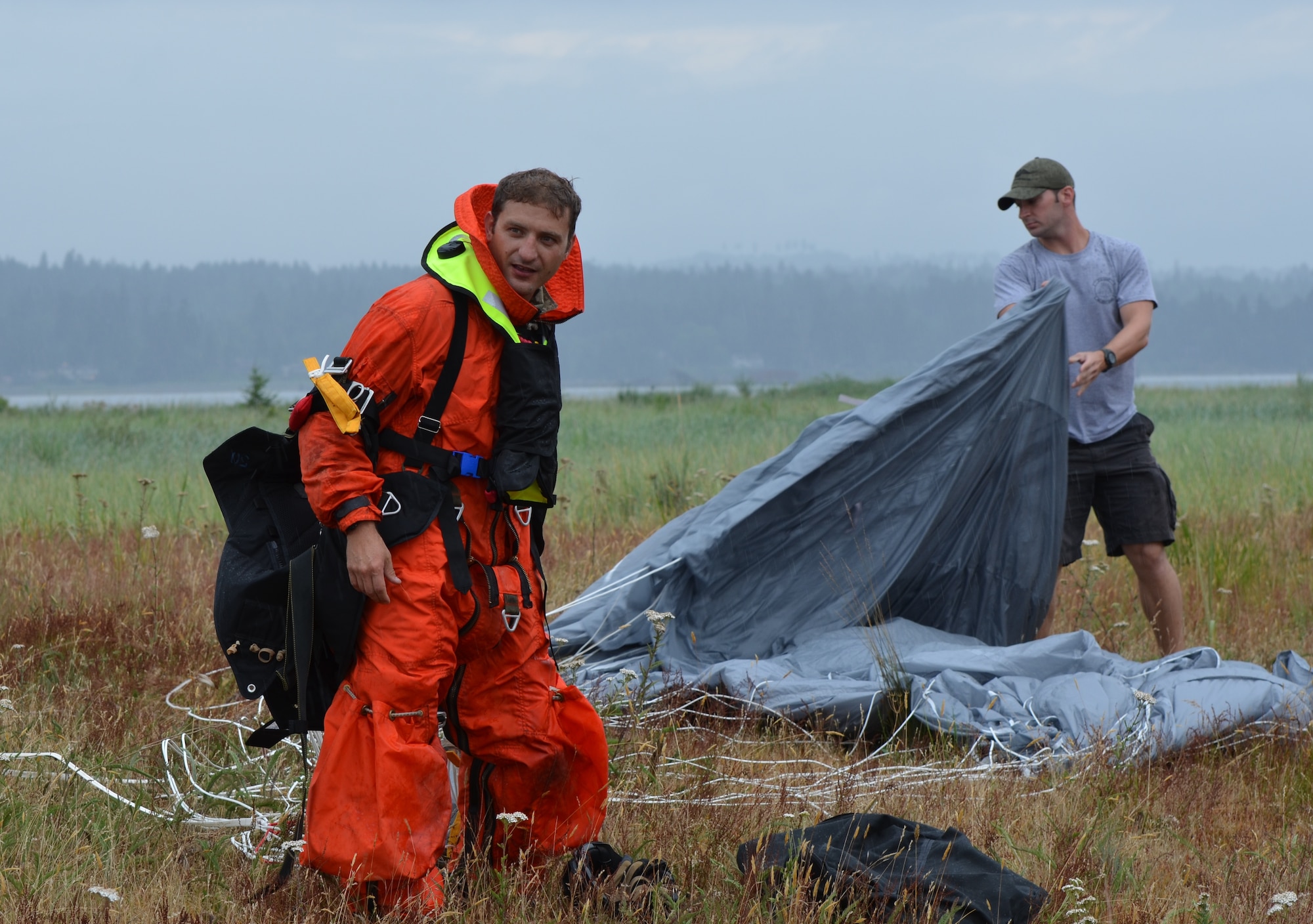 Tech. Sgt. Josh Yarbrough (right), a parachute rigger from the 920th Rescue Wing, helps Staff Sgt. Rich Boyd, a 308th Rescue Squadron pararescueman, pack his parachute after a static line jump in Comox Valley, Canada, July 20, 2012. Pararescuemem from the 308th Rescue Squadron, part of the 920th RQW at Patrick Air Force Base, Fla., participates in three exercises with Canadian search-and-rescue personnel annually. (U.S. Air Force photo/Staff Sgt. Anna-Marie Wyant)