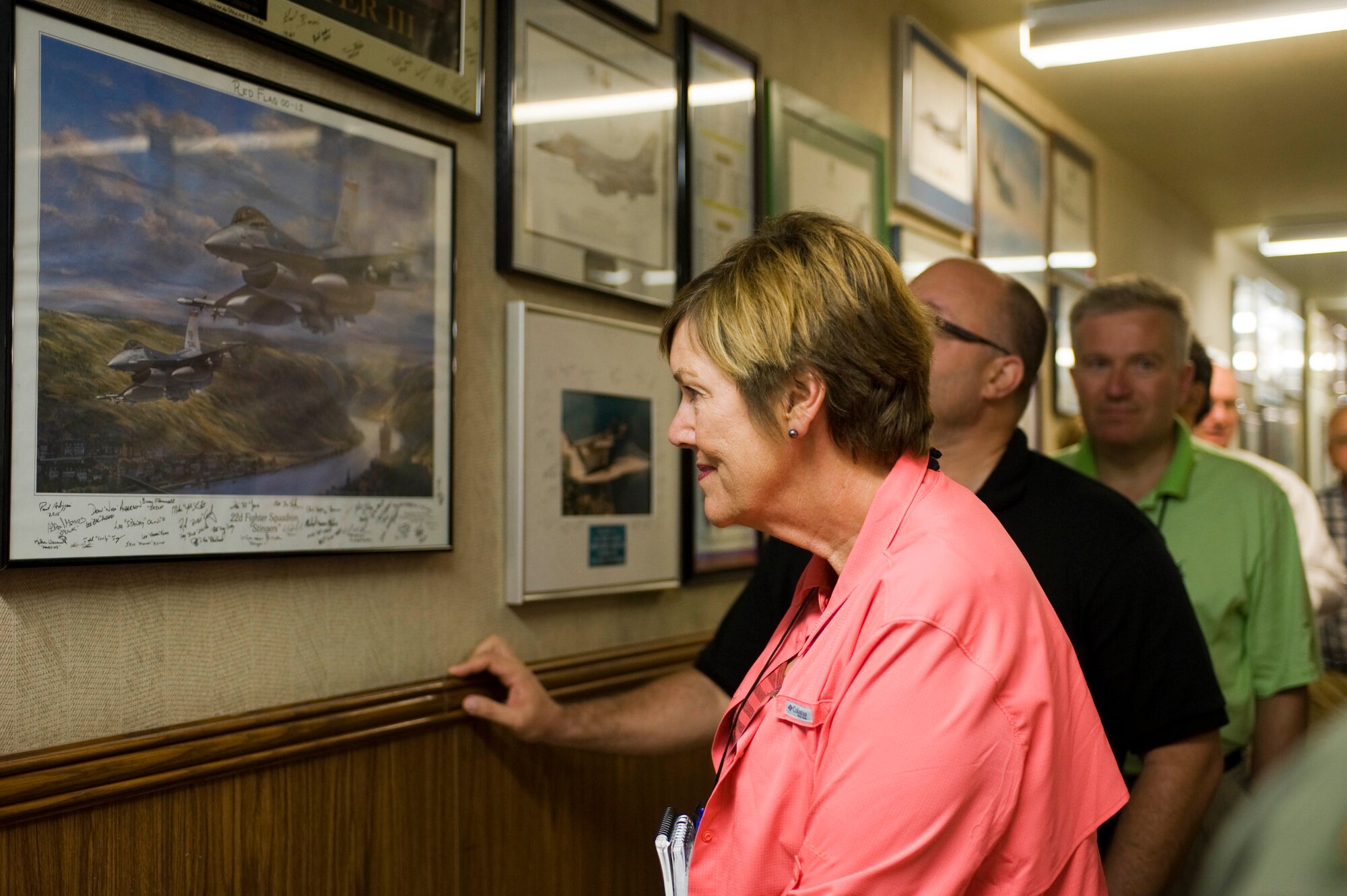 Distinguished visitors with the Joint Civilian Orientation Conference, tour the halls of the Nevada Test and Training Range July 23, 2012, at Nellis Air Force Base, Nev. A JCOC has been held every year since 1948 except for the years 1961, 1971, 1975, 1976 and 1977. (U.S. Air Force photo by Airman 1st Class Christopher Tam)