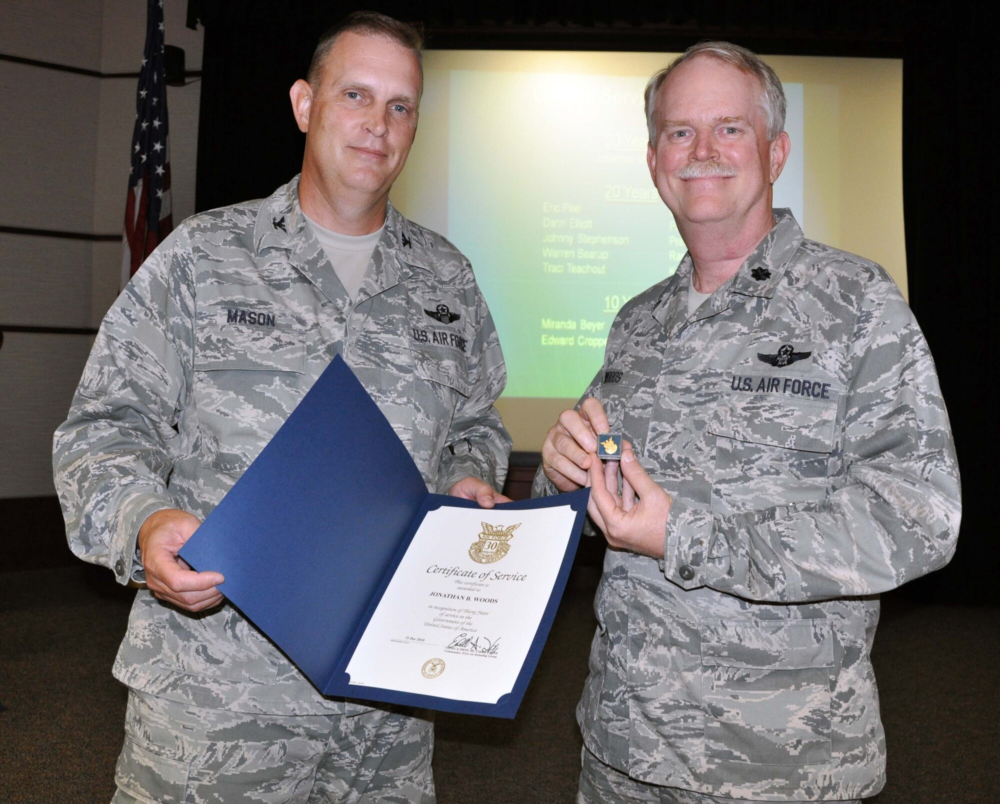 Col. William H. Mason, commander of the 931st Air Refueling Group, presents a pin and certificate commemorating 30 years of civil service to Lt. Col. Jonathan Woods.  Woods is an Air Reserve Technician, which is a full-time, civil service employee serving in a selected position within a military unit.  (U.S. Air Force photo by 1st Lt. Zach Anderson)