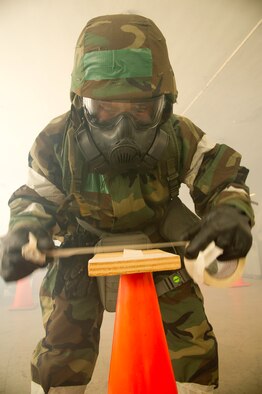 Staff Sgt. Alejandro Pedraza, 452d Aeromedical Staging Squadron, changes M8 paper while in mission operating protective posture gear, level four, during an ATSO rodeo. (U.S. Air Force photos by Staff Sgt. Matthew Smith)