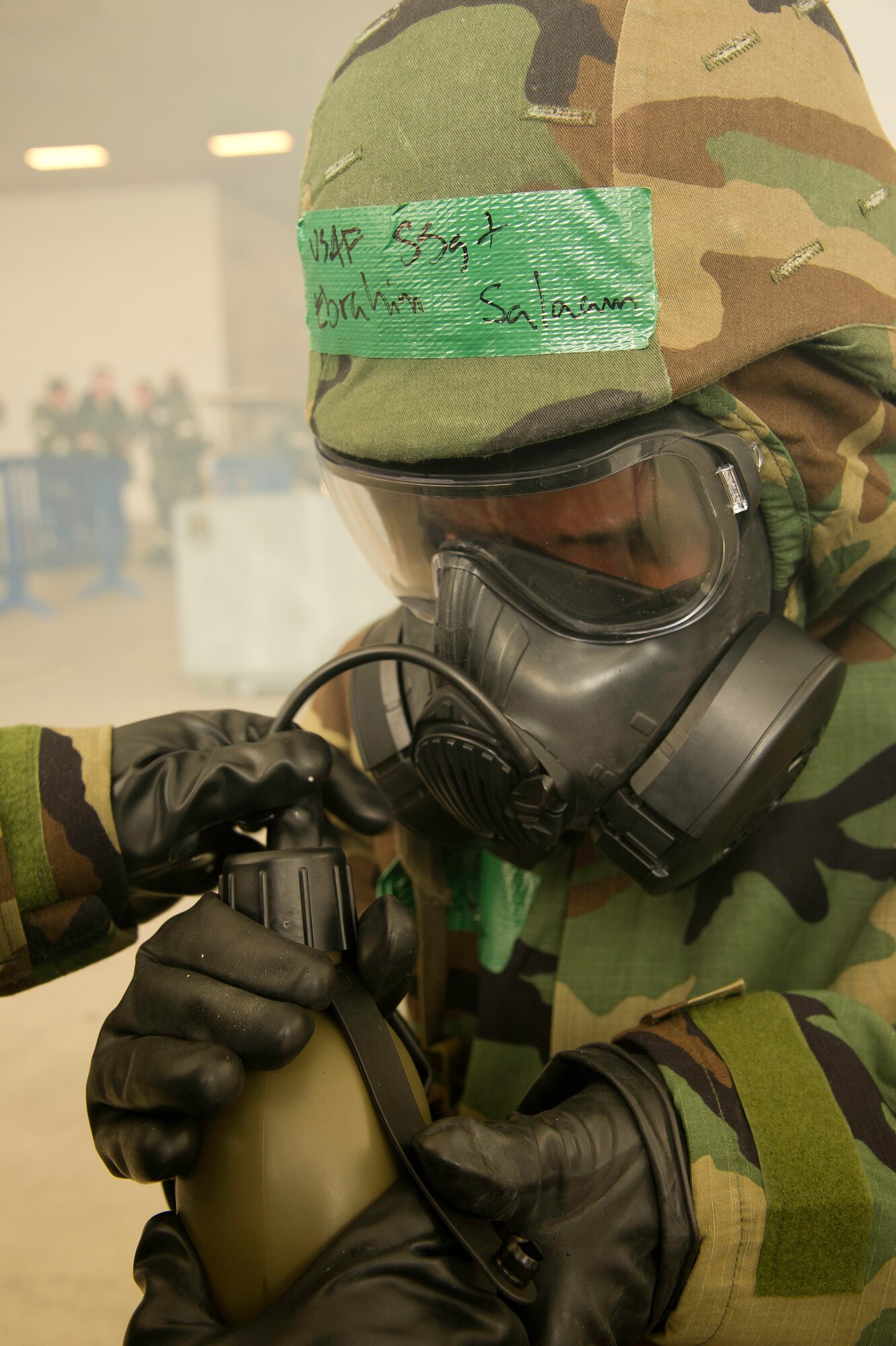 U.S. Air Force Staff Sgt.Ebrahim Salaam, 452d Aeromedical Staging Squadron, practices drinking in a contaminated environment while wearing mission operating protective posture gear, level four, during Ability to Survive and Operate Rodeo at March Air Reserve Base, Calif., July 22, 2012. The ATSO rodeo helps prepare Airmen for an upcoming operational readiness exercise. (U.S. Air Force photo by Staff Sgt. Matthew Smith)