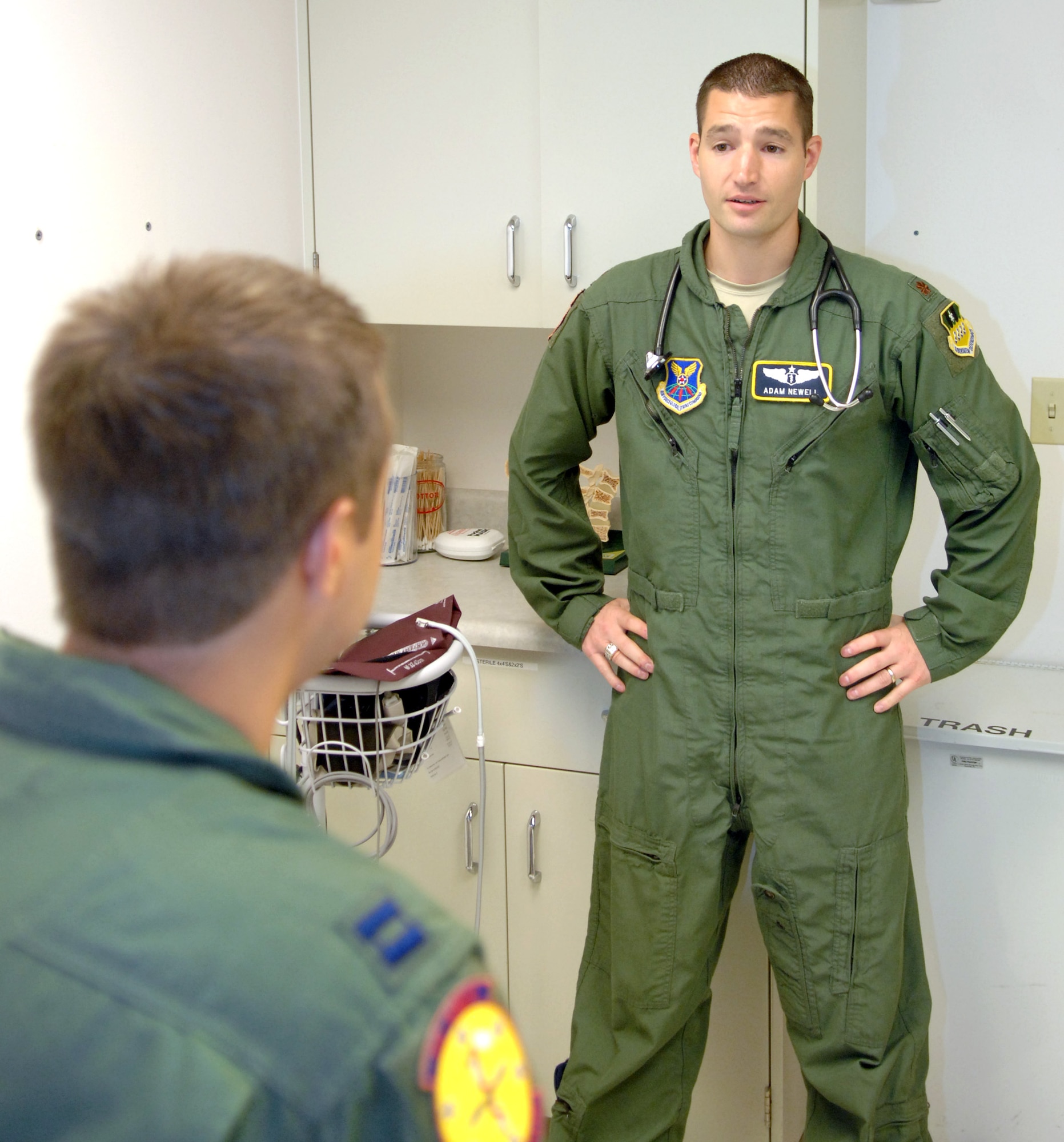 Maj. Adam Newell 2nd Medical Group Flight Medicine, chief of flight medicine, demonstrates how flight doctors discuss the medical options of a patient with fellow physician Capt. Frank Janes, 2 MDG Flight Medicine general medical officer, at Barksdale Air Force Base, La., July 26. The flight medicine works closely with the base's aircrew to meet mission goals. (U.S. Air Force photo/Staff Sgt. Jason McCasland)(RELEASED)
