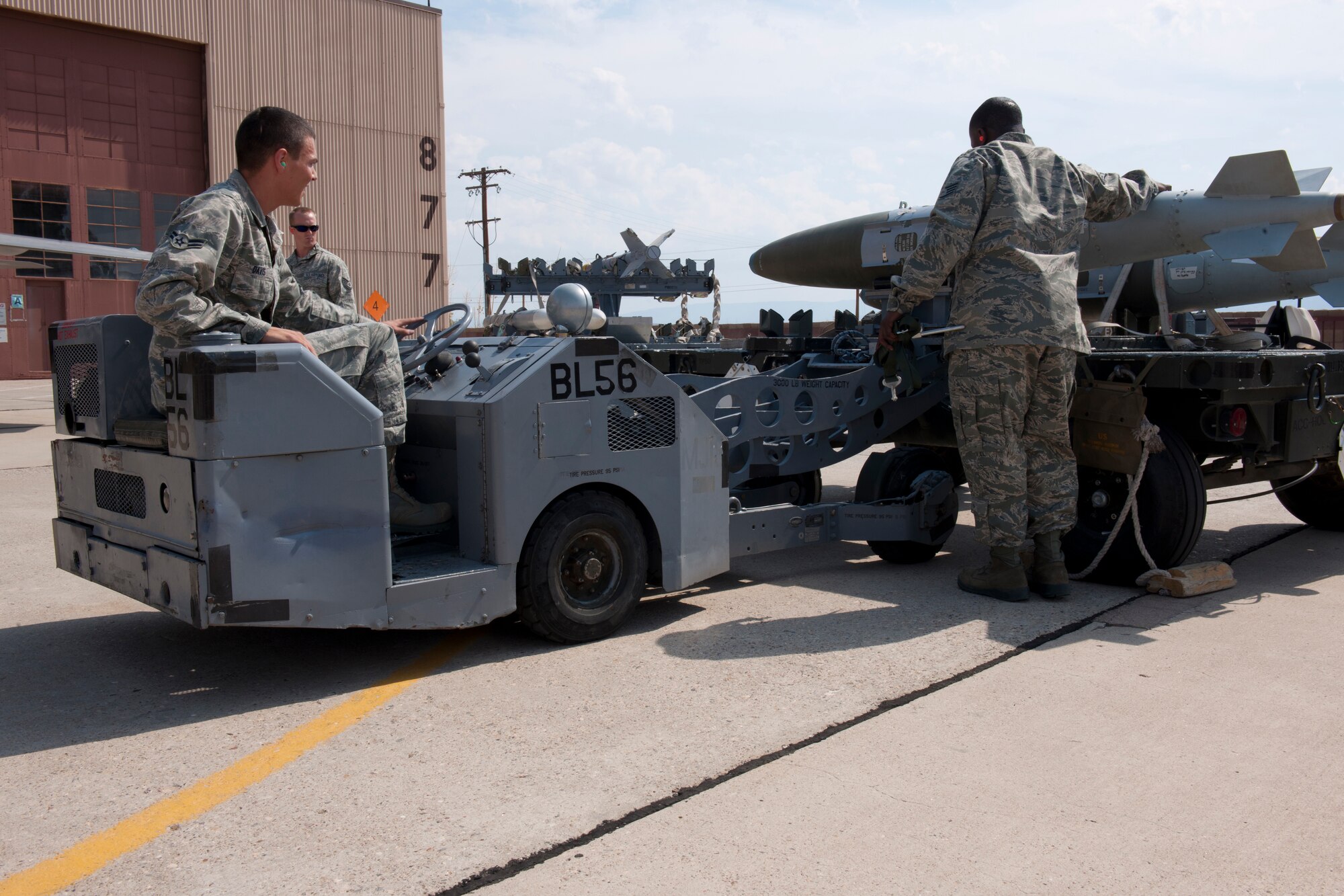 Load team members of the 49th Aircraft Maintenance Squadron use a MJ-1 loading vehicle to pick up a GBU-32 satellite navigation bomb during a quarterly load-crew competition at Holloman Air Force Base, N.M., July 13. The 49th AMXS load crew competed in the load-crew completion to have their skills evaluated alongside the German Air Force Tornado and MQ-9 Reaper load-crews. (U.S. Air Force photo by Airman 1st Class Michael Shoemaker)