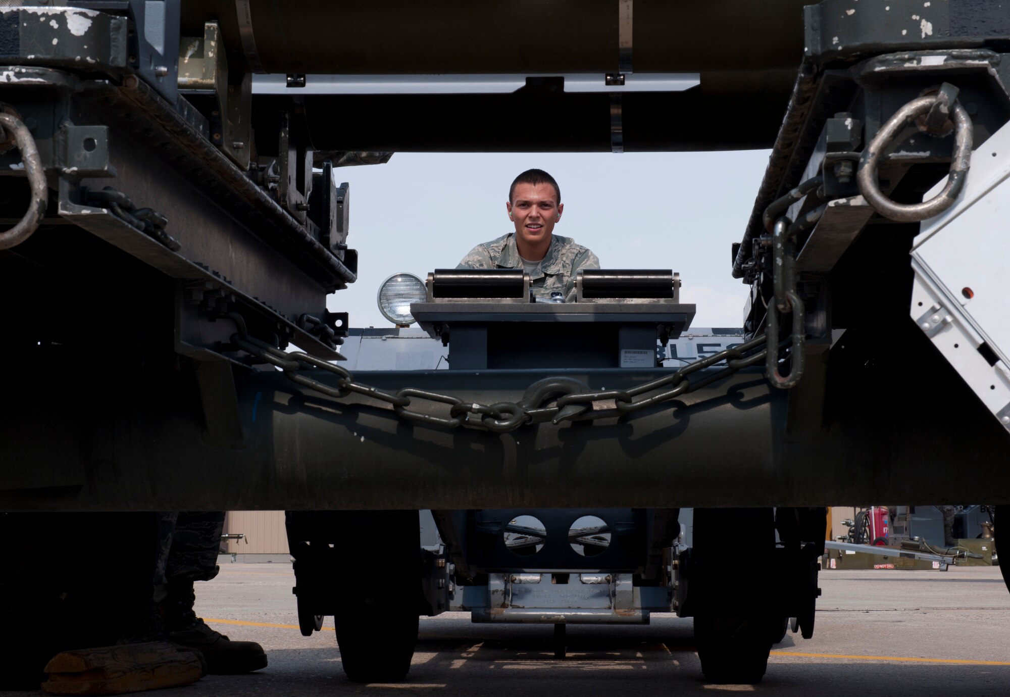 Airman 1st Class Chad Davis, 49th Aircraft Maintenance Squadron load team member, uses a MJ-1 loading vehicle to pick up a GBU-32 satellite navigation bomb during a quarterly load-crew competition at Holloman Air Force Base, N.M., July 13. Load-crew competitions are held on a quarterly basis and are used to help build morale through friendly competition. (U.S. Air Force photo by Airman 1st Class Michael Shoemaker)