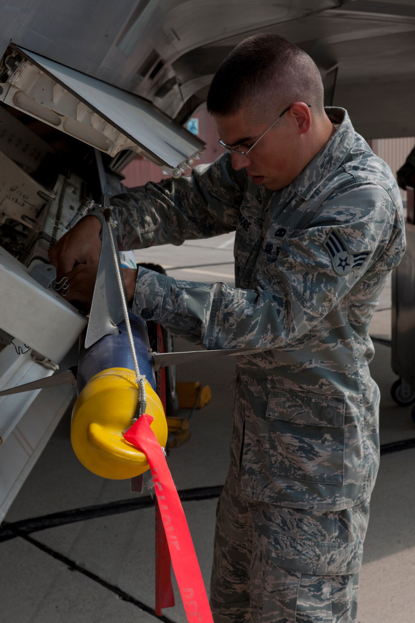 Senior Airman Thomas Moore, 49th Aircraft Maintenance Squadron load team member, attaches a Captive-Air Training Missile AIM- 9L to an F-22 Raptor during a quarterly load-crew competition at Holloman Air Force Base, N.M., July 13. The 49th AMXS load-crew competed in the load-crew competition to have their skills evaluated alongside the German Air Force Tornado and MQ-9 Reaper load crews. (U.S. Air Force photo by Airman 1st Class Michael Shoemaker)