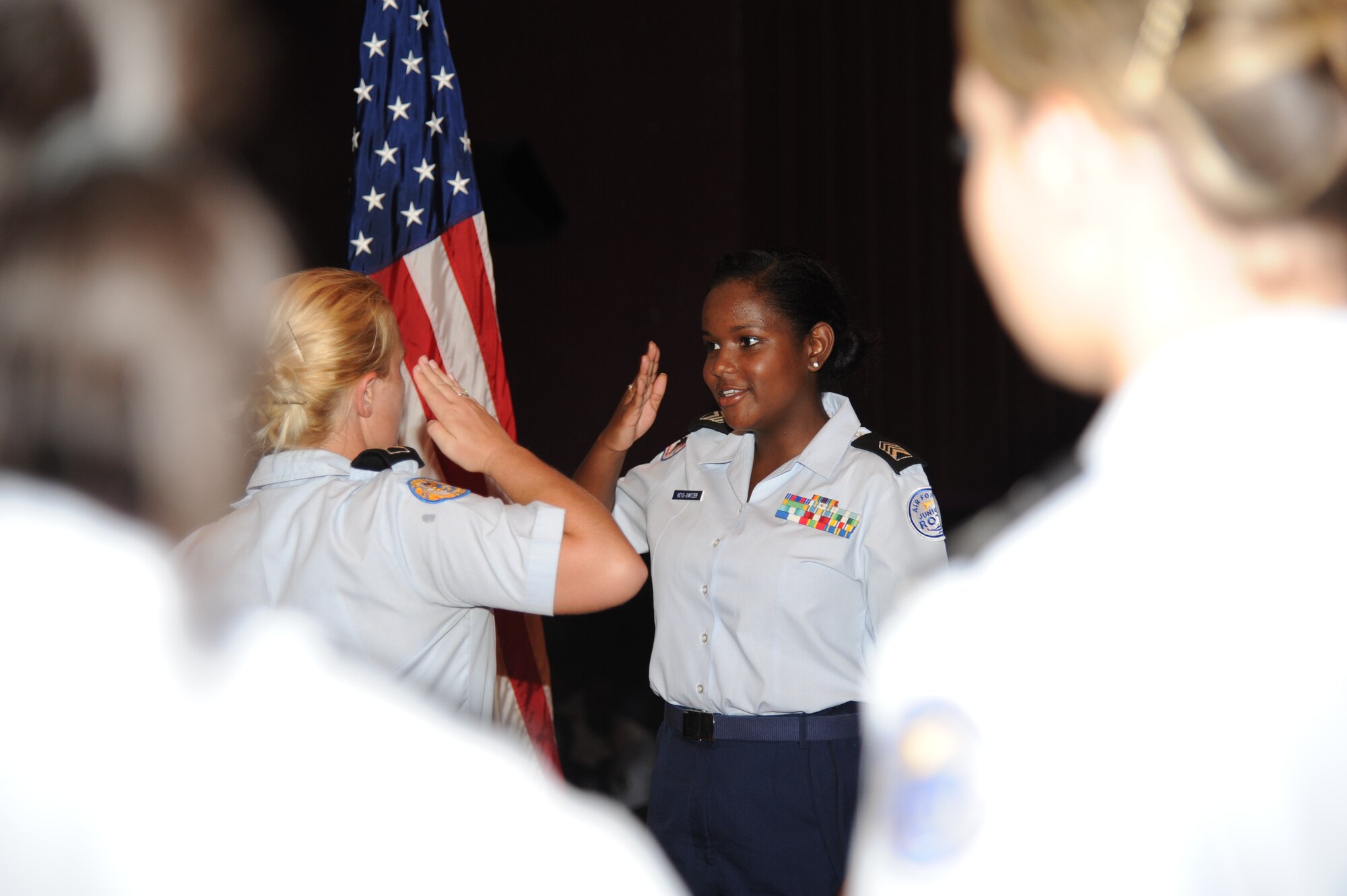 Cadet Christina Pollan, 17, a senior from St. Martin High School, salutes Cadet Col. Deedra Keys-Switzer, 17, a senior from Biloxi High School, during a JROTC graduation ceremony July 27, 2012, at the Welch Theater, Keesler Air Force Base, Miss. Approximately 100 JROTC students from seven states attended a week-long JROTC Summer Leadership School at Keesler ending with a parade and the graduation ceremony.  (U.S. Air Force photo by Kemberly Groue)