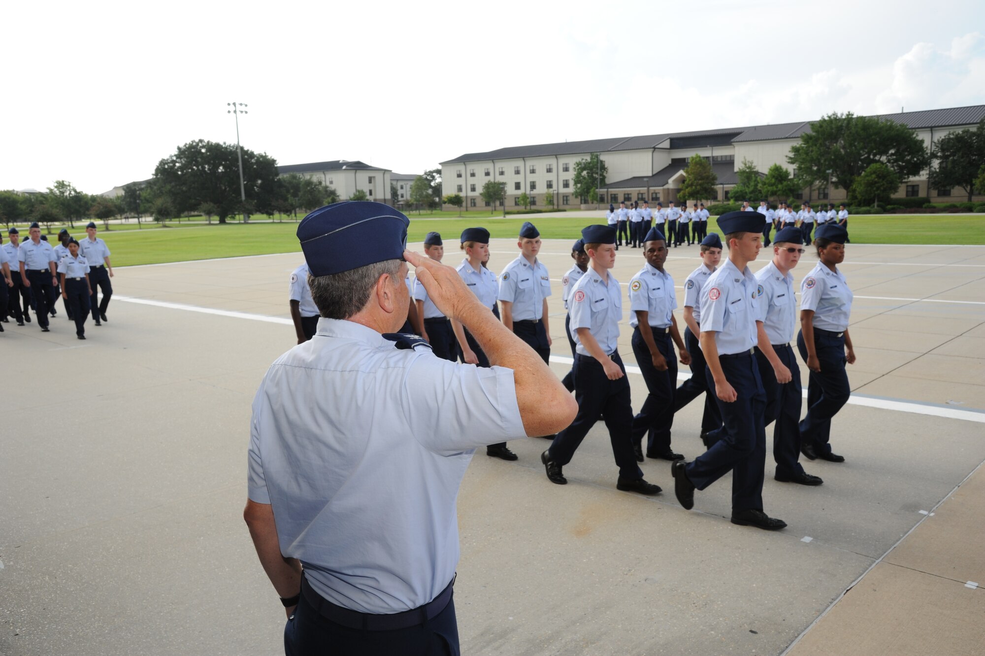 Col. Joseph Reich, Destrahan High School JROTC program senior instructor, Destrahan, La., salutes JROTC cadets as they pass in formation during a parade at the Levitow Training Support Facility, Keesler Air Force Base, Miss., July 27, 2012.  Approximately 100 JROTC students from seven states attended a week-long JROTC Summer Leadership School at Keesler ending with the parade and a graduation ceremony at the Welch Theater.  (U.S. Air Force photo by Kemberly Groue)