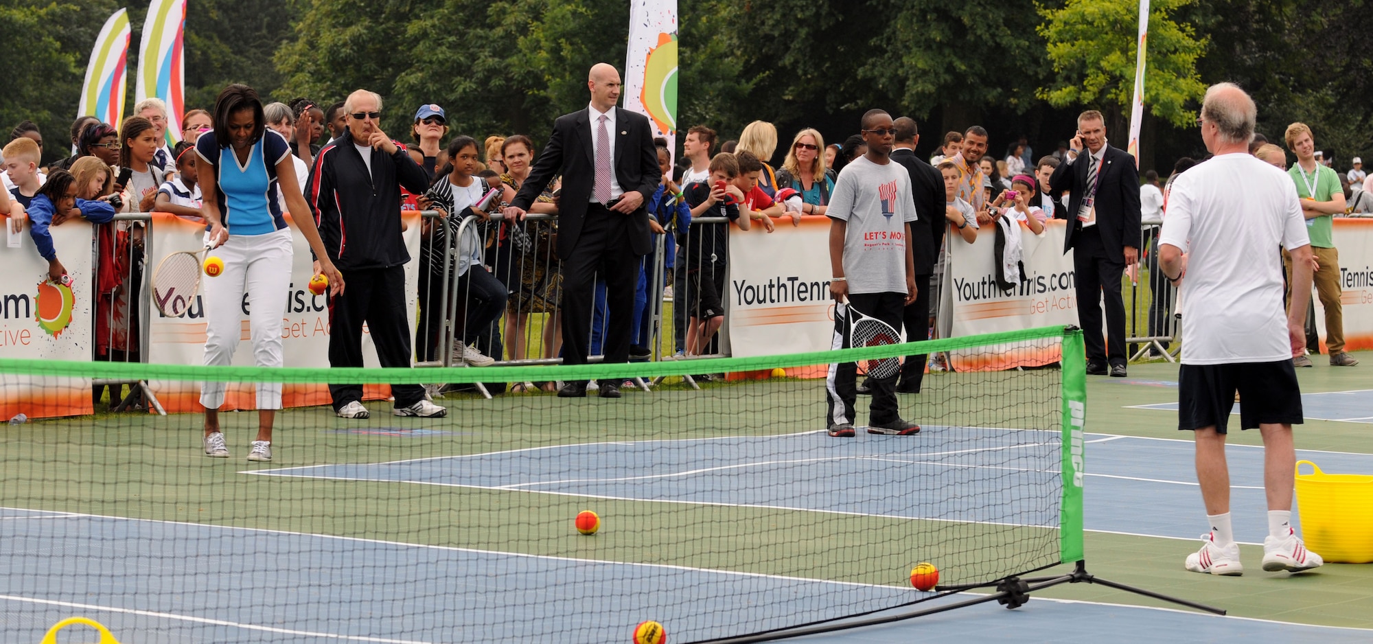 LONDON – First lady Michelle Obama plays doubles tennis with Ajani Tonge, 12, son of Tech. Sgt. Latisha Cole, 100th Air Refueling Wing public affairs, at the United States Ambassador to the United Kingdom’s residence during a fitness-themed event July 27, 2012. The festivities were part of first lady Michelle Obama’s “Let’s Move!” campaign to combat childhood obesity. The first lady and several Olympic athletes took turns playing games with the kids. (U.S. Air Force photo/Staff Sgt. Austin M. May)
