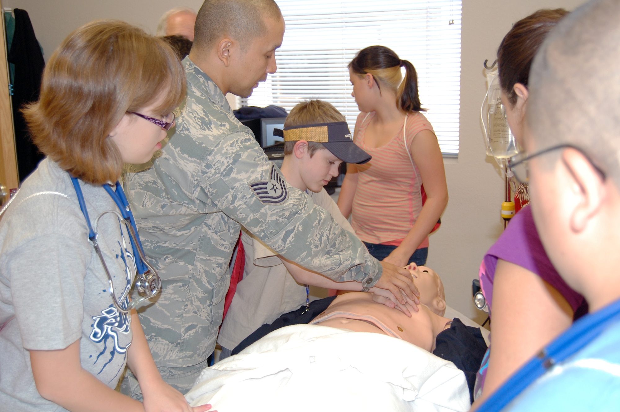ech. Sgt. Ovendalin Brown, 56th Medical Support Squadron education and training NCO-in-charge, demonstrates chest compressions May 3 for Thompson Ranch Elementary School students during a tour of the 56th Medical Group. (Courtesy photo)