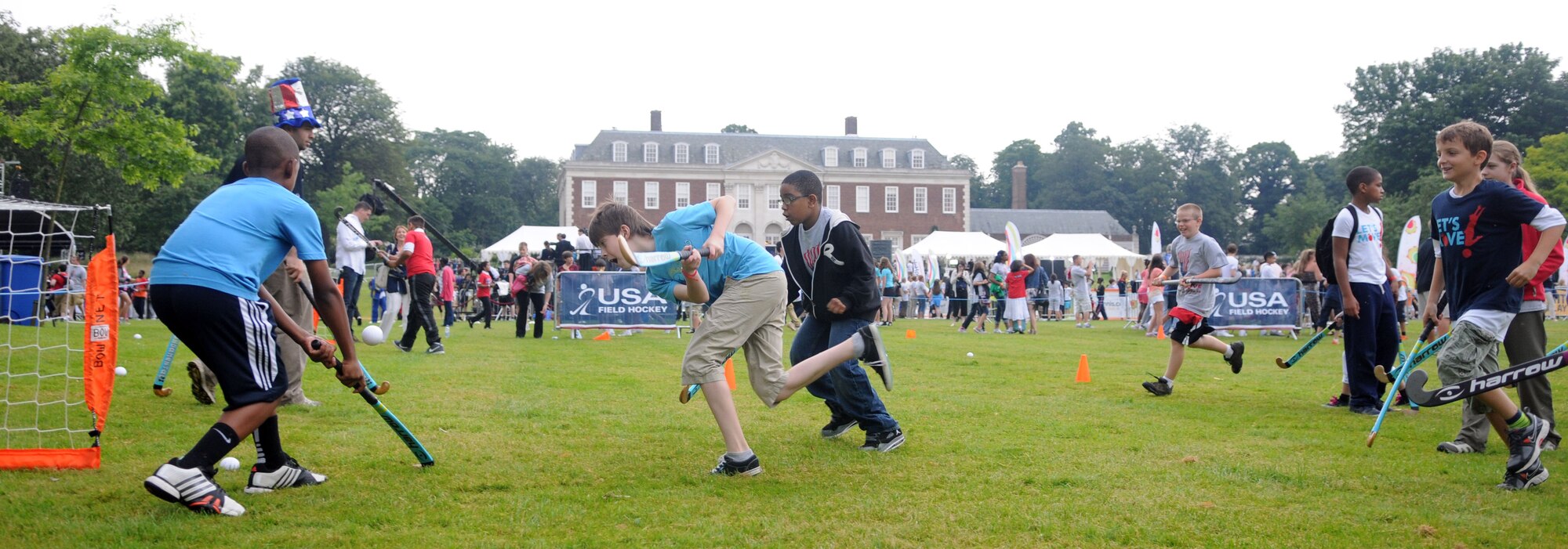 LONDON – Children from the United States and the United Kingdom play field hockey at the United States Ambassador to the United Kingdom’s residence during a fitness-themed event July 27, 2012. Members of the USA Olympic Field Hockey team joined in the fun. (U.S. Air Force photo/Staff Sgt. Austin M. May)