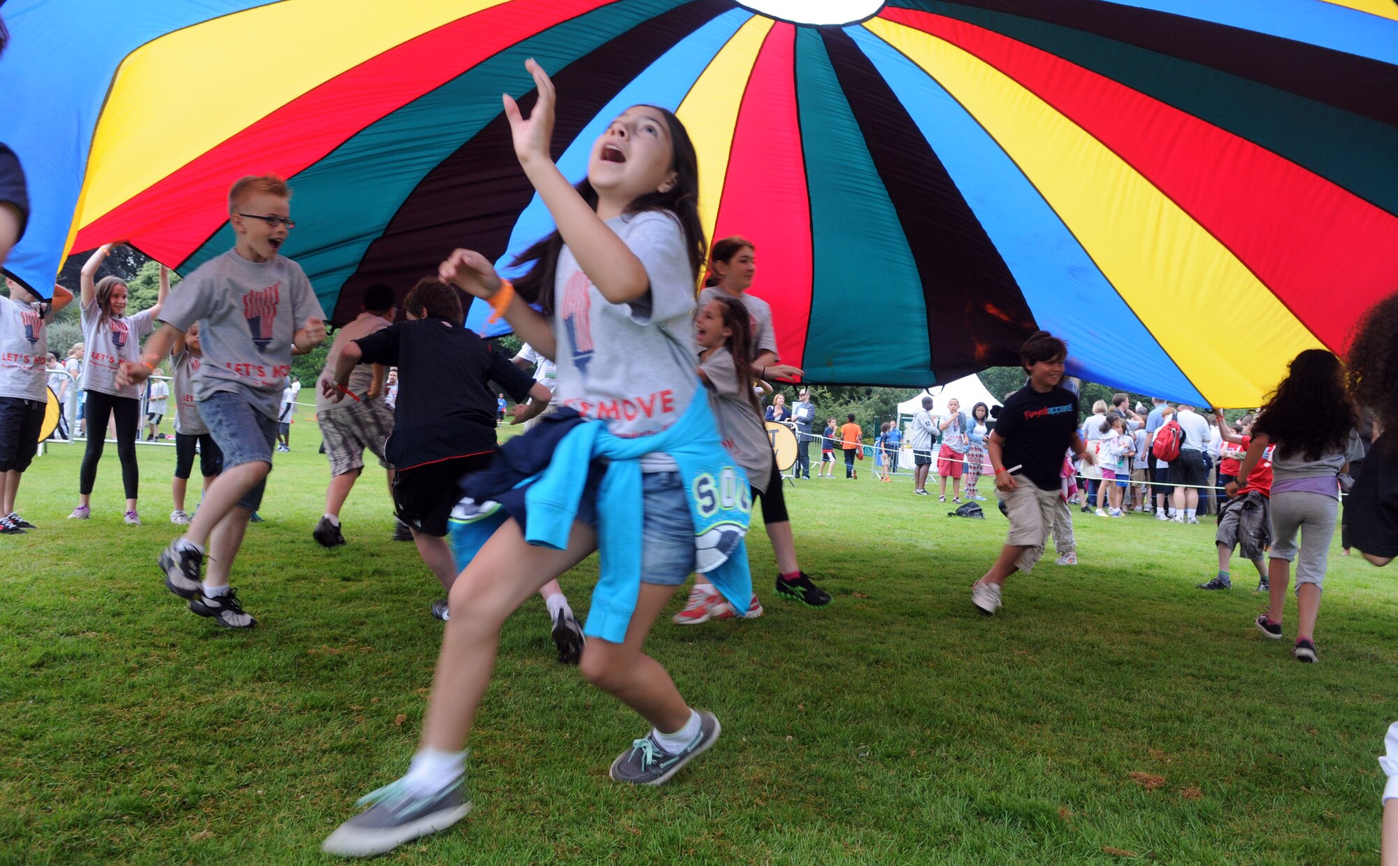 LONDON – Children from the United States and the United Kingdom play parachute games at the United States Ambassador to the United Kingdom’s residence during a fitness-themed event July 27, 2012. The festivities were part of first lady Michelle Obama’s “Let’s Move!” campaign to combat childhood obesity. The first lady and several star athletes joined in the games. (U.S. Air Force photo/Staff Sgt. Austin M. May)