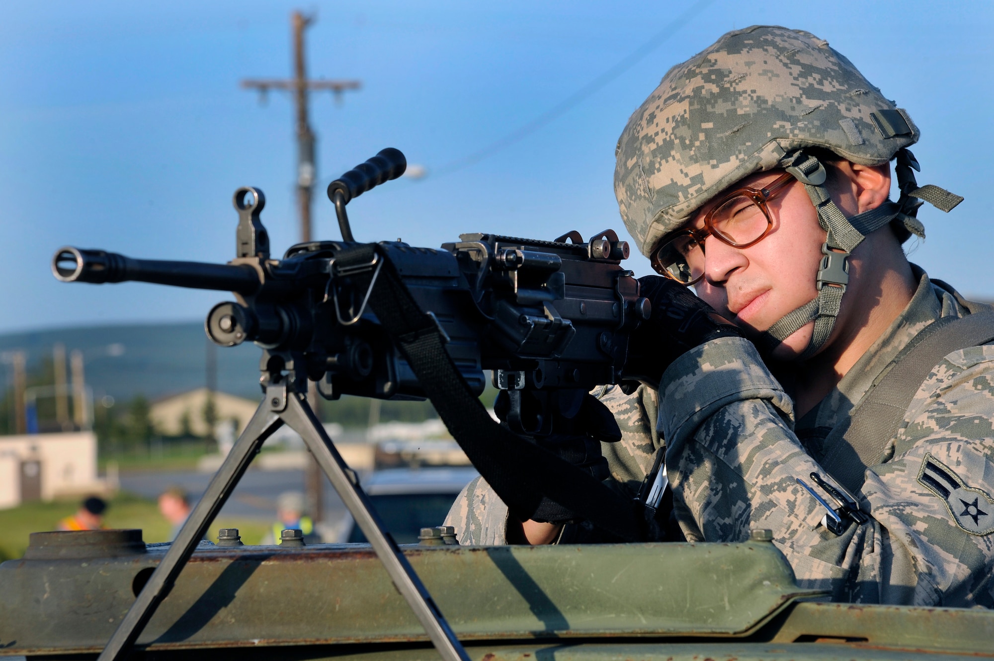 U.S. Air Force Airman 1st Class Joshua Garcia, 354th Security Forces Squadron security forces specialist, takes aim with an M-249 light machine gun during an operational readiness exercise July 26, 2012, Eielson Air Force Base, Alaska. The exercise trains security forces extensively in law enforcement and combat tactics to support both stateside and overseas missions. (U.S. Air Force photo/Staff Sgt. Jim Araos)