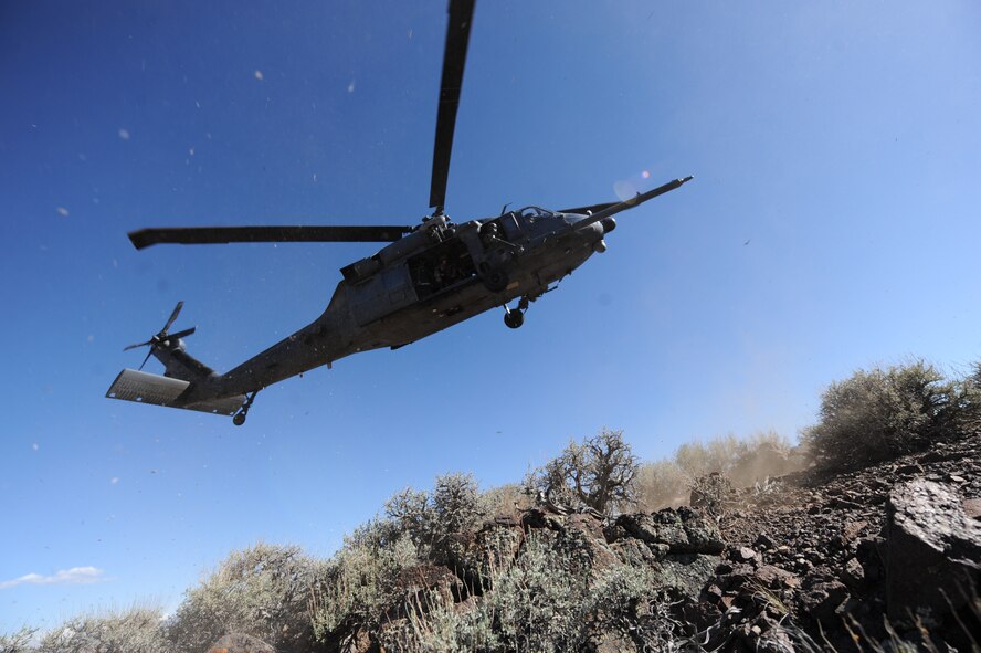 A rescue crew from the 66th and 58th Rescue Squadrons at Nellis Air Force Base, Nev., land at the Nevada Test and Training Range July 24, 2012, to recover isolated personnel during a combat search and rescue exercise scenario. These things they do, that others may live. (U.S. Air Force photo by Master Sgt. Sonny Cohrs)