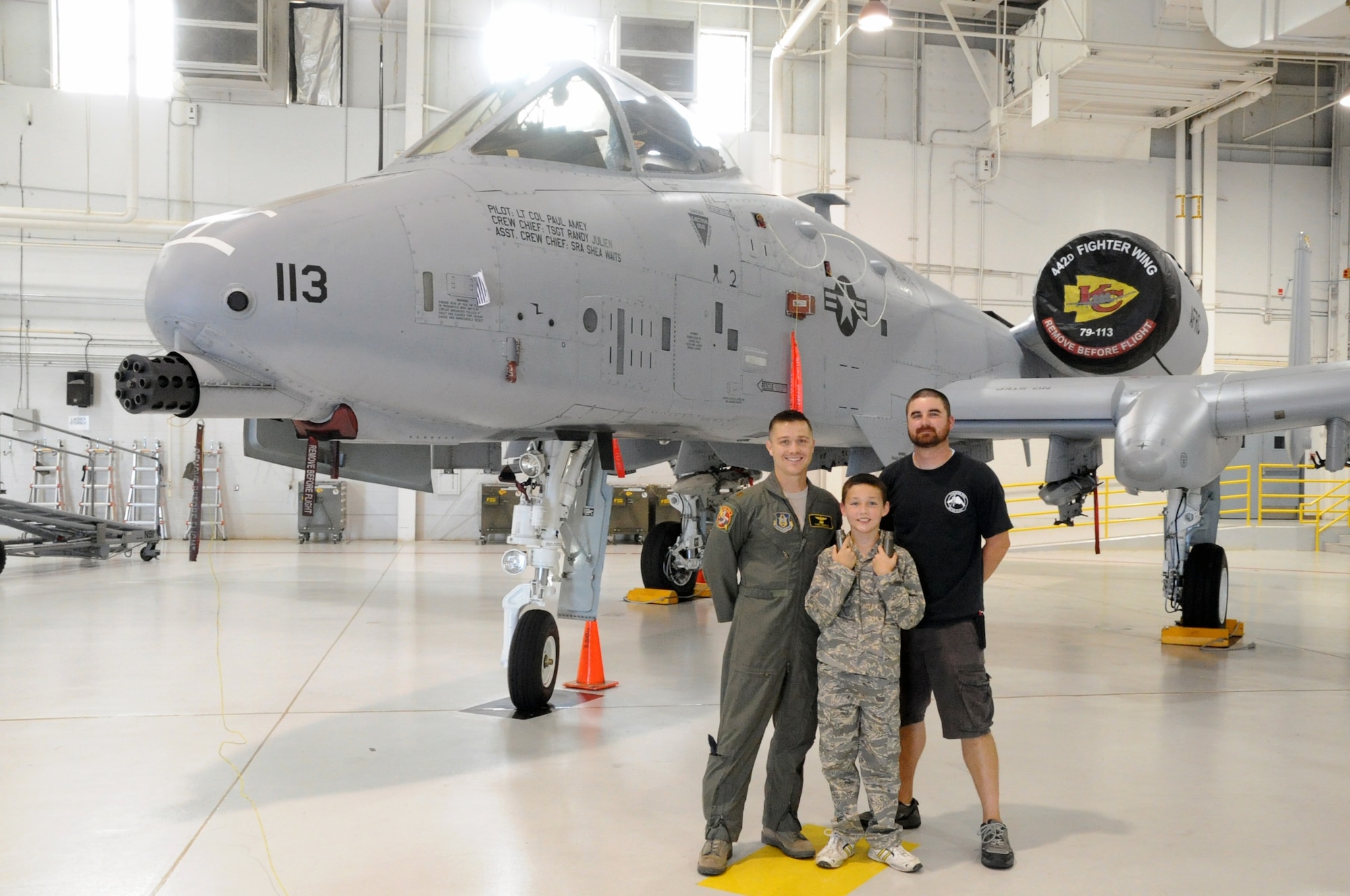 WHITEMAN AIR FORCE BASE, Mo. -- Maj. Todd Riddle (left), A-10 Thunderbolt II pilot, and Justin Kelley (right), A-10 crew chief, talk to Michael Gracey, fourth-grade student, about the A-10 during a tour of the base July 26, 2012. Gracey, the son of an active-duty member here, was diagnosed with attention deficit hyperactive disorder and Asperger's syndrome in 2007. The 442nd Fighter Wing is an Air Force Reserve unit here. 