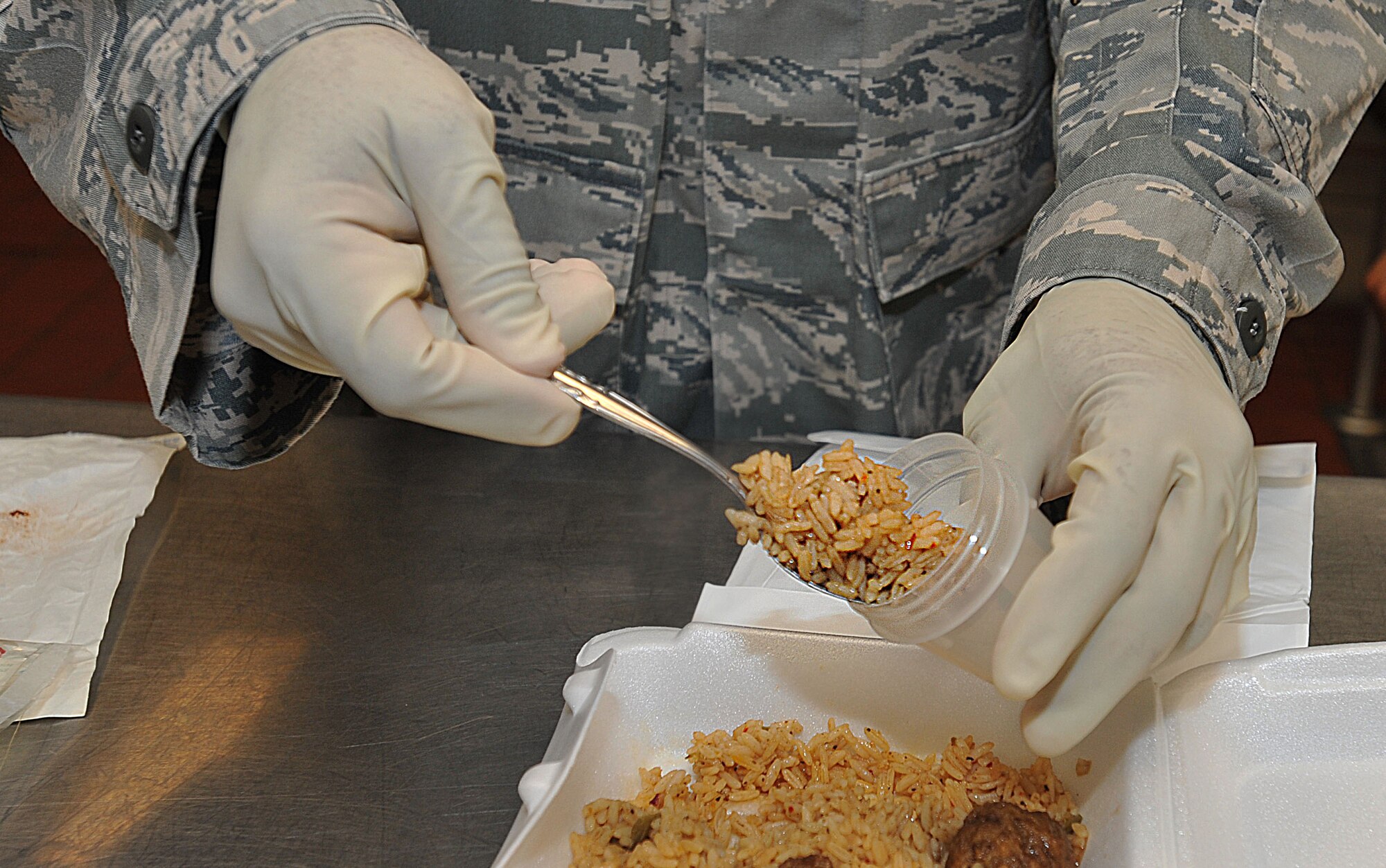 U.S. Air Force Airman 1st Class Derek Guess, 633rd Aerospace Medicine Squadron public health technician, stores samples of simulated-contaminated food during a terrorist use of chemical, biological, radiological, nuclear and high-yield explosive exercise, July 26, 2012, at Langley Air Force Base, Va.  Guess participated as a member of the sampling team, working jointly with 633rd Air Base Wing observers and inspectors throughout the exercise. (U.S. Air Force photo by Senior Airman Stephanie Rubi/Released)  
