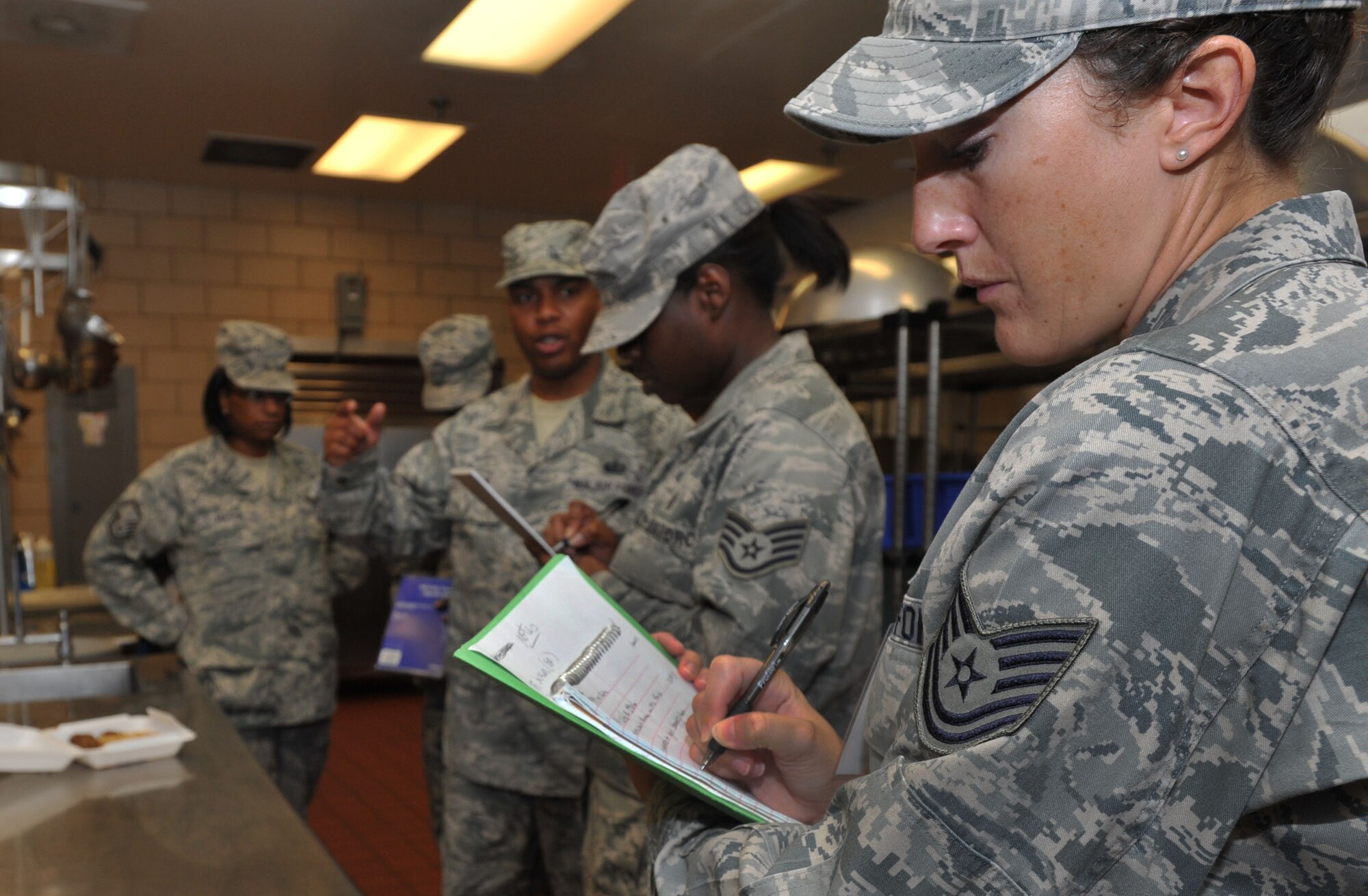 U.S. Air Force Tech. Sgt. Misty Smith, 633rd Aerospace Medicine Squadron Wing Evaluation Exercise Team member observes and evaluates inspectors searching for simulated-food contamination during a terrorist use of chemical, biological, radiological, nuclear and high-yield explosive exercise, July 26, 2012, at Langley Air Force Base, Va.  The four-hour exercise evaluated the 633rd Air Base Wing’s ability to react and respond to a possible CBRNE event. (U.S. Air Force photo by Senior Airman Stephanie Rubi/Released)