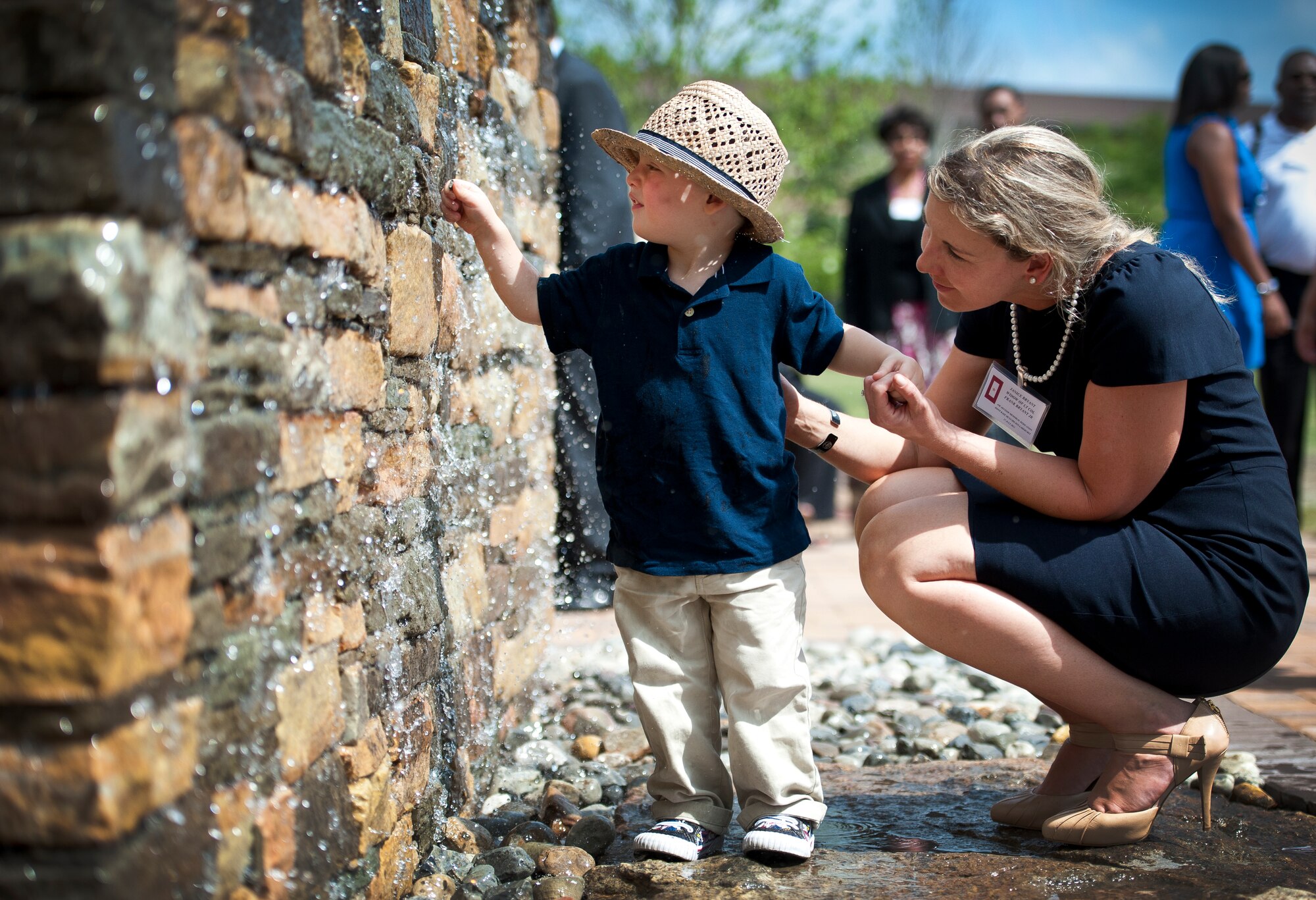 Sean Bryant and his mother Janice get a close view of the waterfall at the Air Advisor Memorial at Joint Base McGuire-Dix-Lakehurst, N.J., July 27, 2012. Sean is the son of fallen Air Force air advisor Lt. Col. Frank Bryant Jr., who is one of nine air advisors killed Afghanistan on April 27, 2011. (U.S. Air Force photo/Senior Airman Andrew Lee)