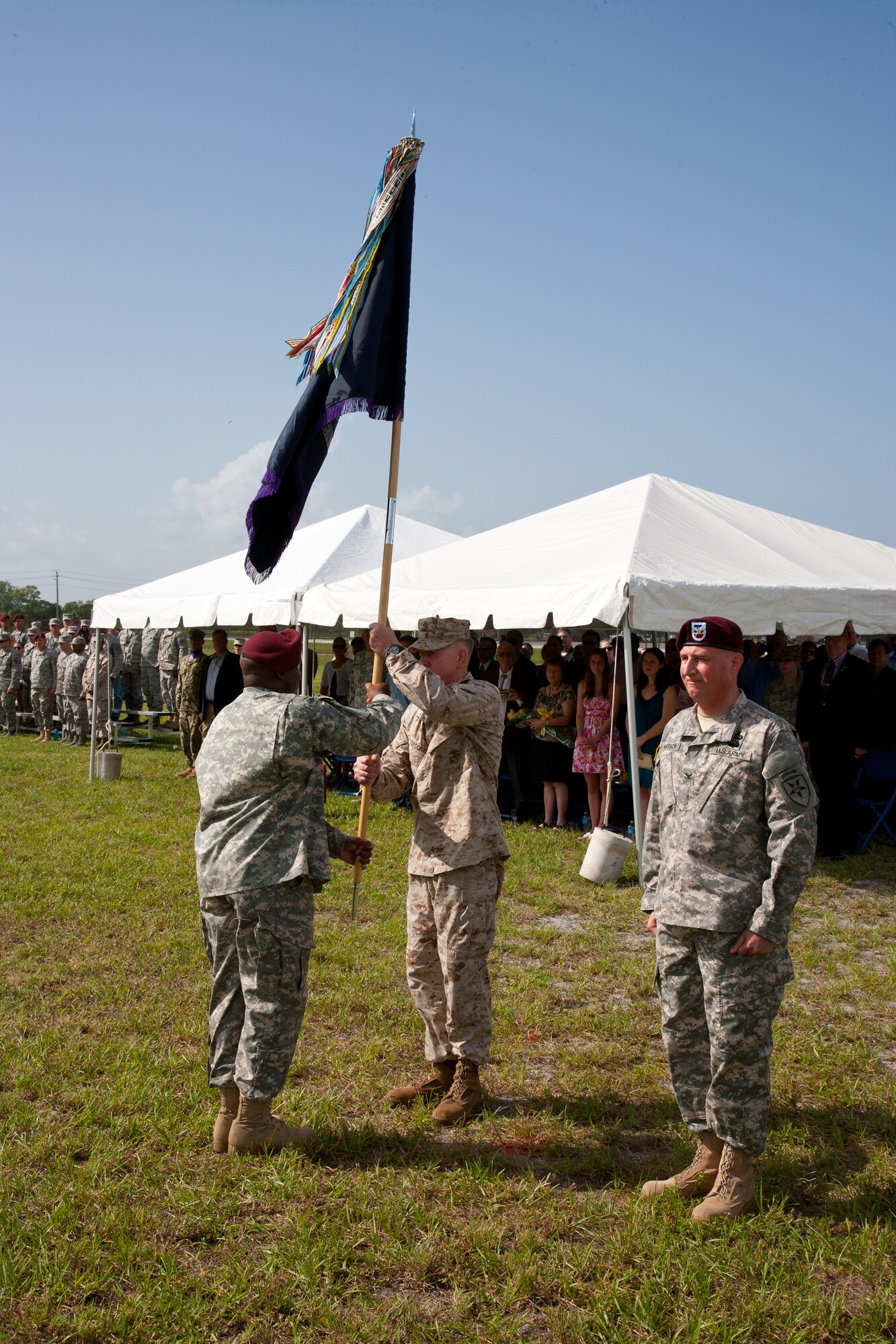 U.S. Army Command Sgt. Maj. Lemuel Brock, the Joint Communications Support Element’s senior enlisted leader, passes the JCSE colors to the outgoing commander, U.S. Marine Corps Col. Stephen P. Corcoran. (Photo by Mr. Rick Maupin, JCSE)