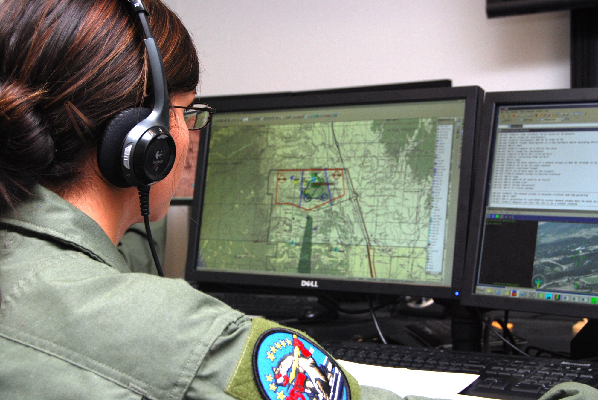 Cadet 3rd Class Kasilie Shepherd coordinates an unmanned aerial system mission in the 557th Flying Training Squadron facility at the Air Force Academy Airfield July 20, 2012. Instructor pilot cadets and permanent-party faculty create scenarios that allow students to work with classmates enrolled in the Expeditionary Survival and Evasion Training summer program, simulating operational Air Force missions. Shepherd is assigned to Cadet Squadron 35. (U.S. Air Force photo/Don Branum)