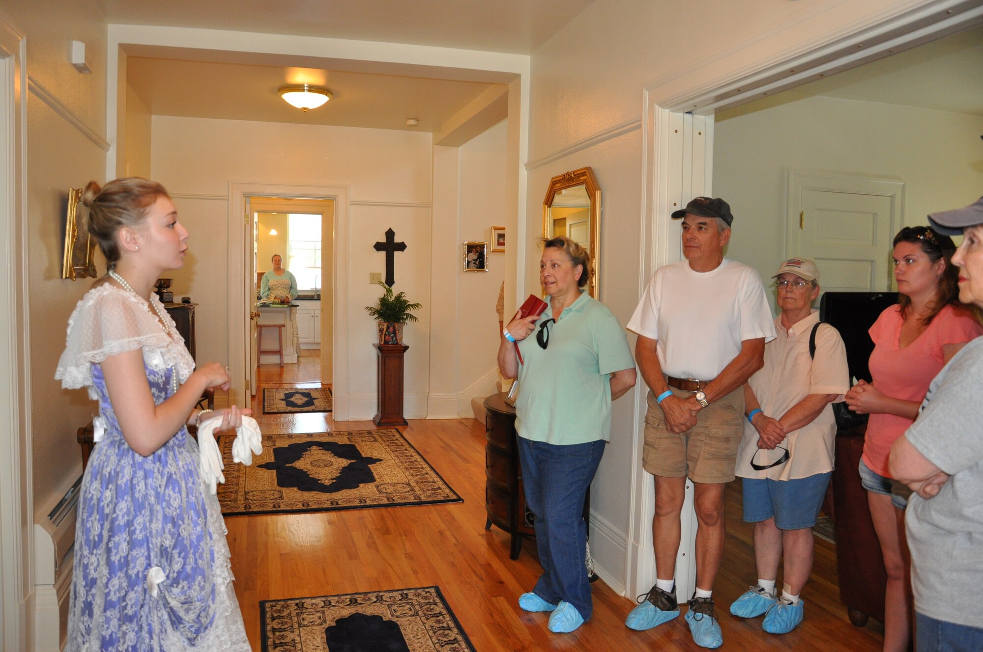 Alex Coffelt, daughter of Col. Christopher Coffelt, 90th Missile Wing commander, explains the historic social customs associated with Quarters 117, home of the Coffelt family, during a Historic Homes Tour, July 22. The tour, which featured three of F. E. Warren’s historical homes, was sponsored by the Warren Spouses Club, and featured during the base’s annual open house, Fort D.A. Russell Days. (U.S. Air Force photo by Staff Sgt. Torri Savarese)