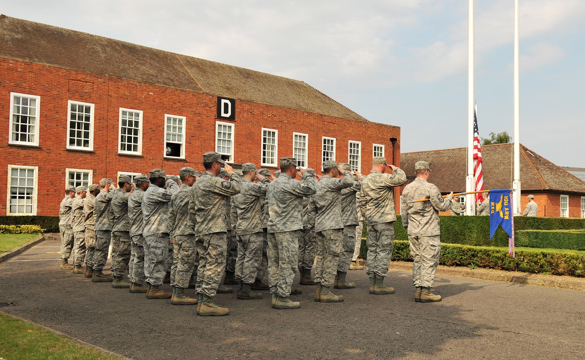 RAF MILDENHALL, England – Airmen from the 100th Maintenance Group salute the flag during a retreat ceremony on RAF Mildenhall July 27, 2012. A retreat ceremony is held here on the last duty day of every month to pay respect and retire the U.S. and Royal Air Force flags. (U.S. Air Force photo/Senior Airman Jerilyn Quintanilla)