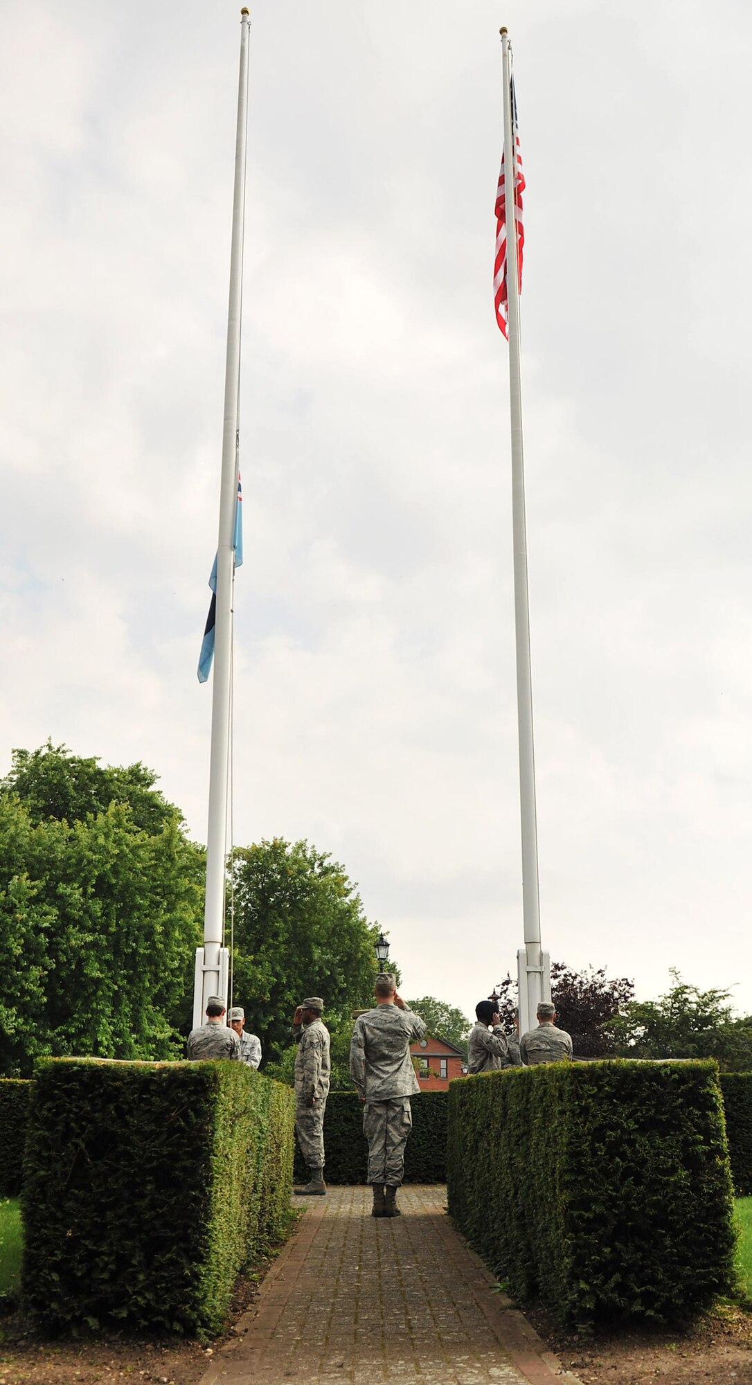 RAF MILDENHALL, England – Airmen from the Team Mildenhall honor guard lower the flags during a retreat ceremony on RAF Mildenhall July 27, 2012. Retreat signals the end of the official duty day. (U.S. Air Force photo/Senior Airman Jerilyn Quintanilla)