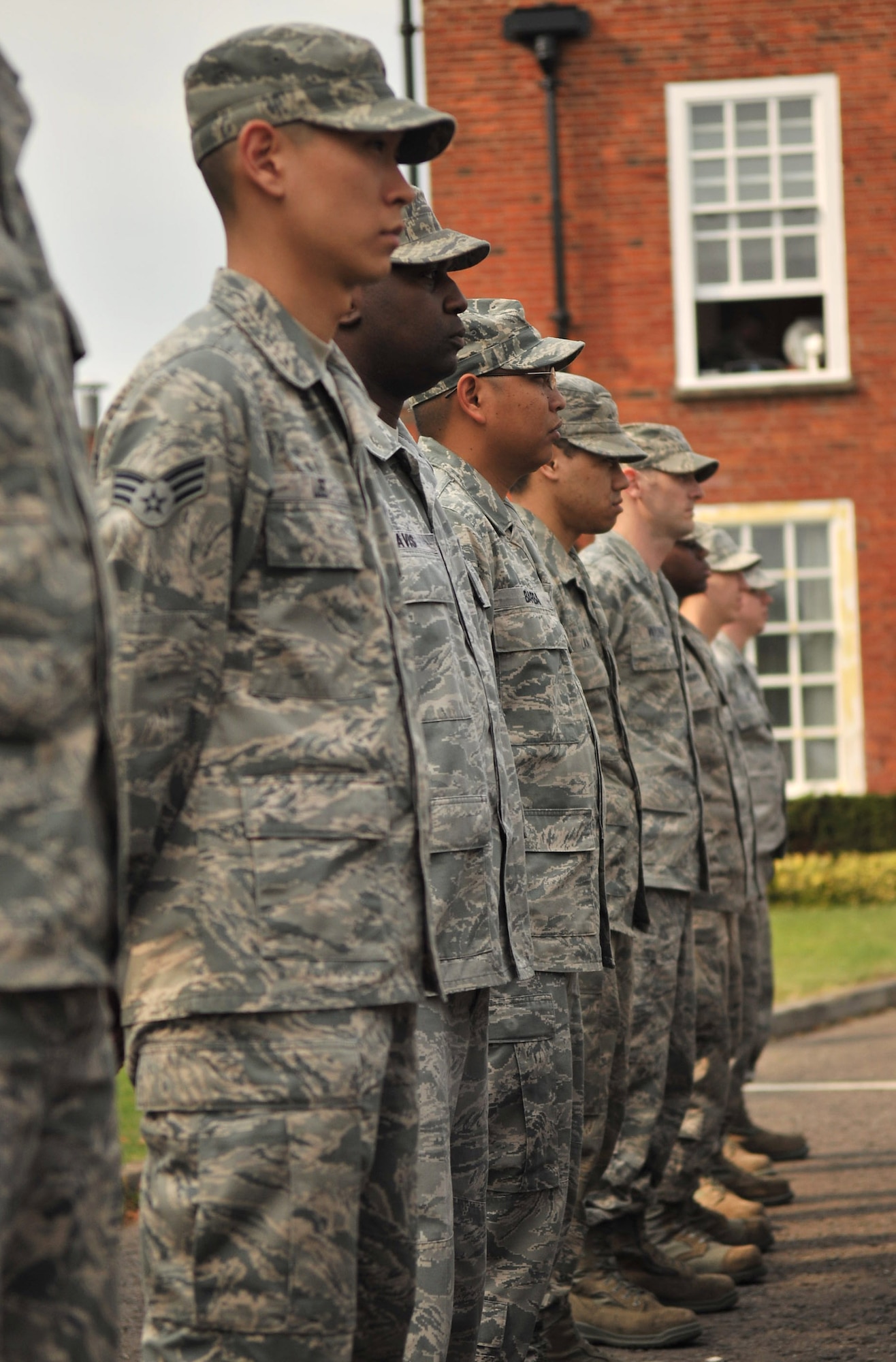 RAF MILDENHALL, England – Airmen from the 100th Maintenance Group stand at parade rest prior to the playing of the U.K. and U.S. national anthems on RAF Mildenhall July 27, 2012. A retreat ceremony, during which the U.S. and Royal Air Force flags are retired, takes place on the last duty day of every month. (U.S. Air Force photo/Senior Airman Jerilyn Quintanilla)